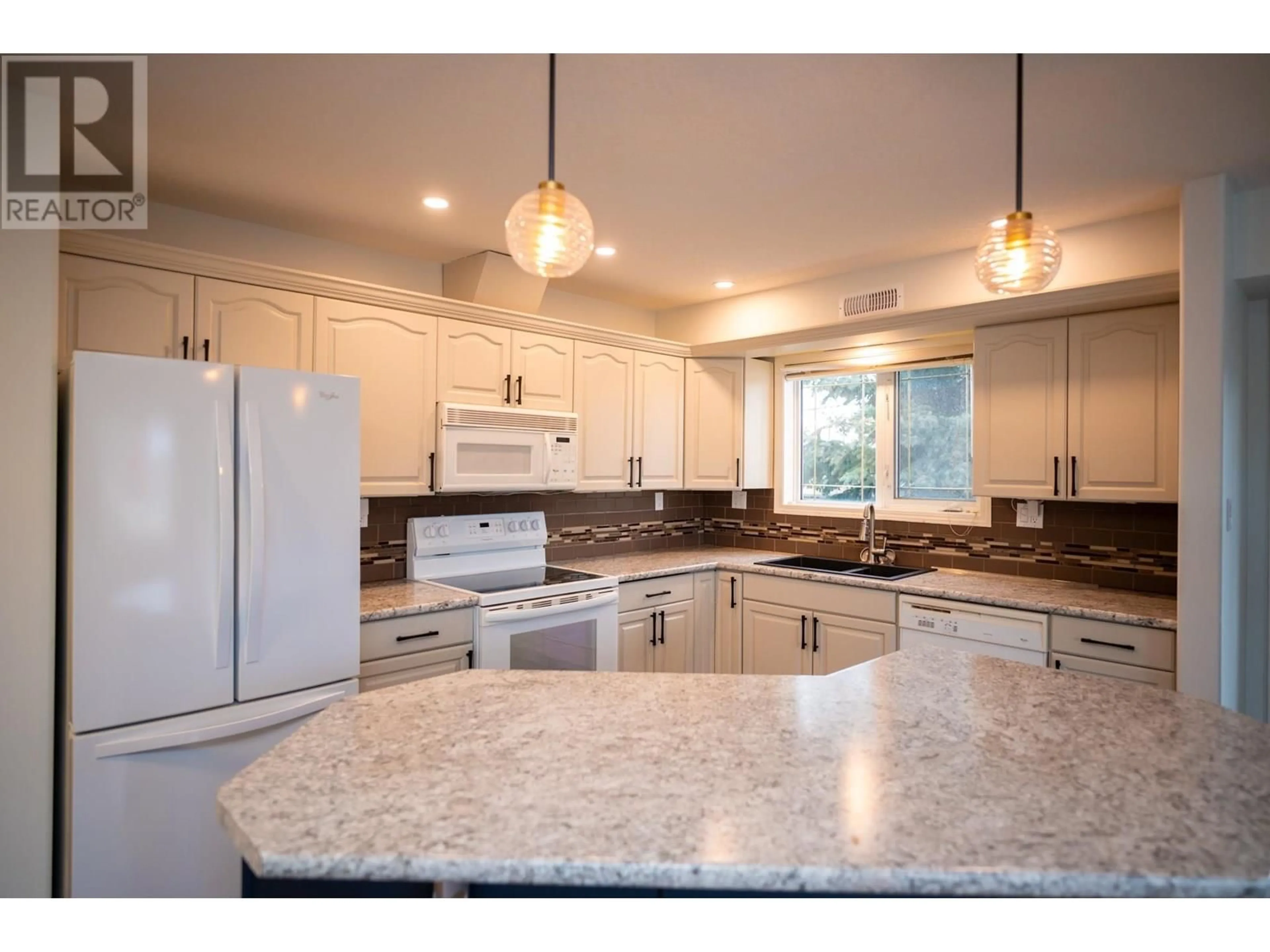Open concept kitchen, ceramic/tile floor for 106 - 1693 6TH AVENUE, Prince George British Columbia V2L3N5