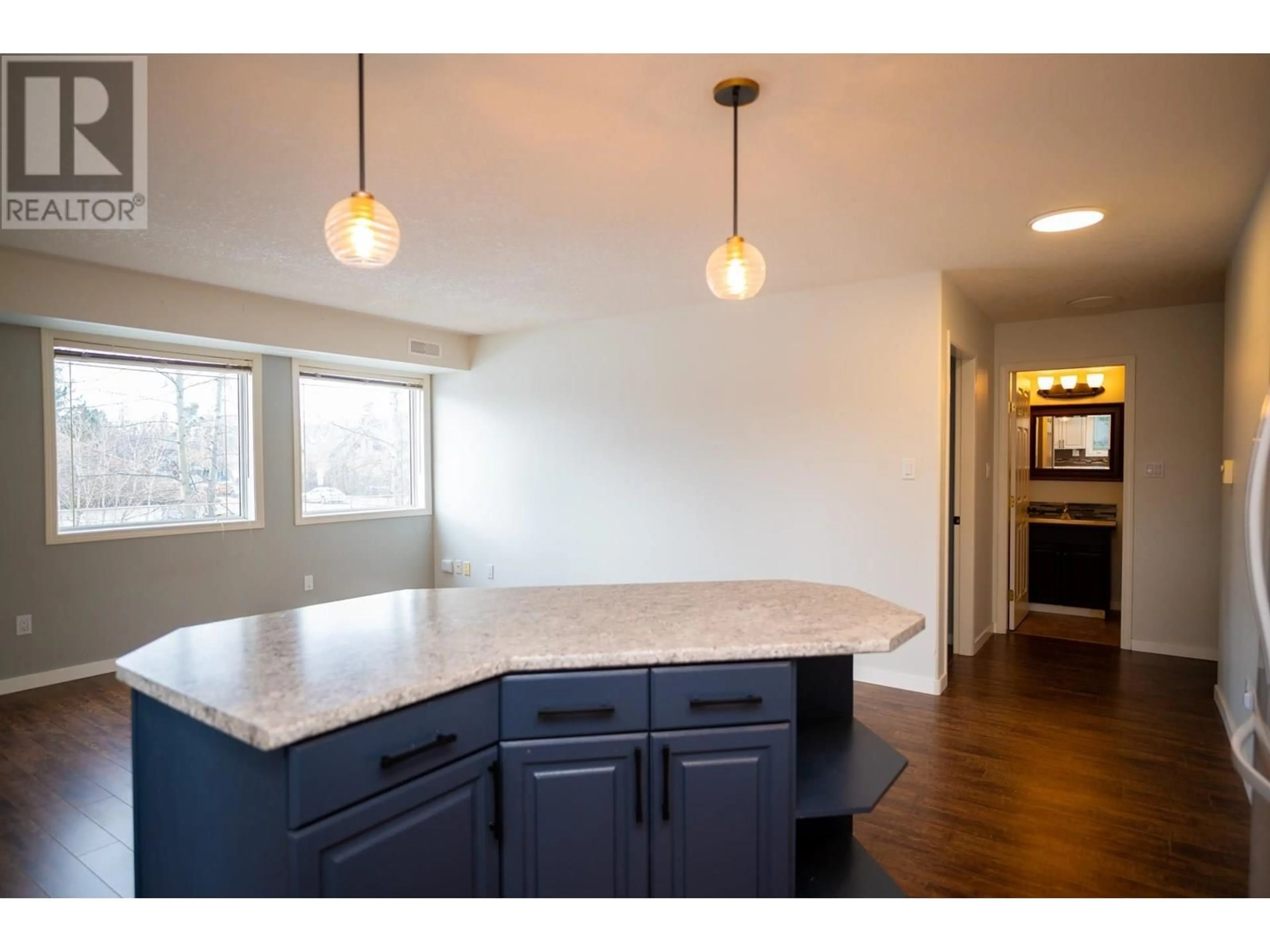 Open concept kitchen, wood/laminate floor for 106 - 1693 6TH AVENUE, Prince George British Columbia V2L3N5