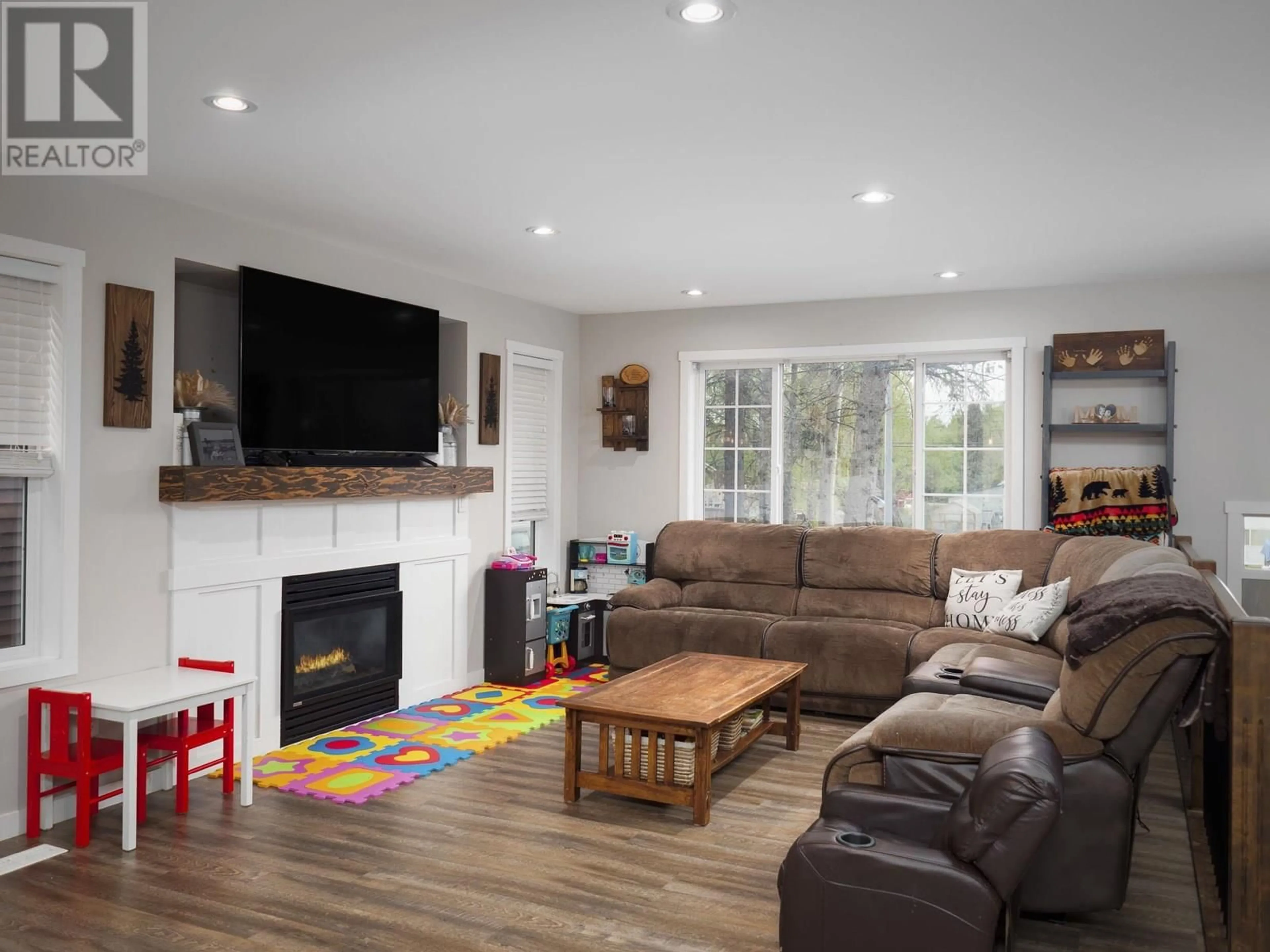 Living room with furniture, wood/laminate floor for 8249 PETER ROAD, Prince George British Columbia V2K0B2