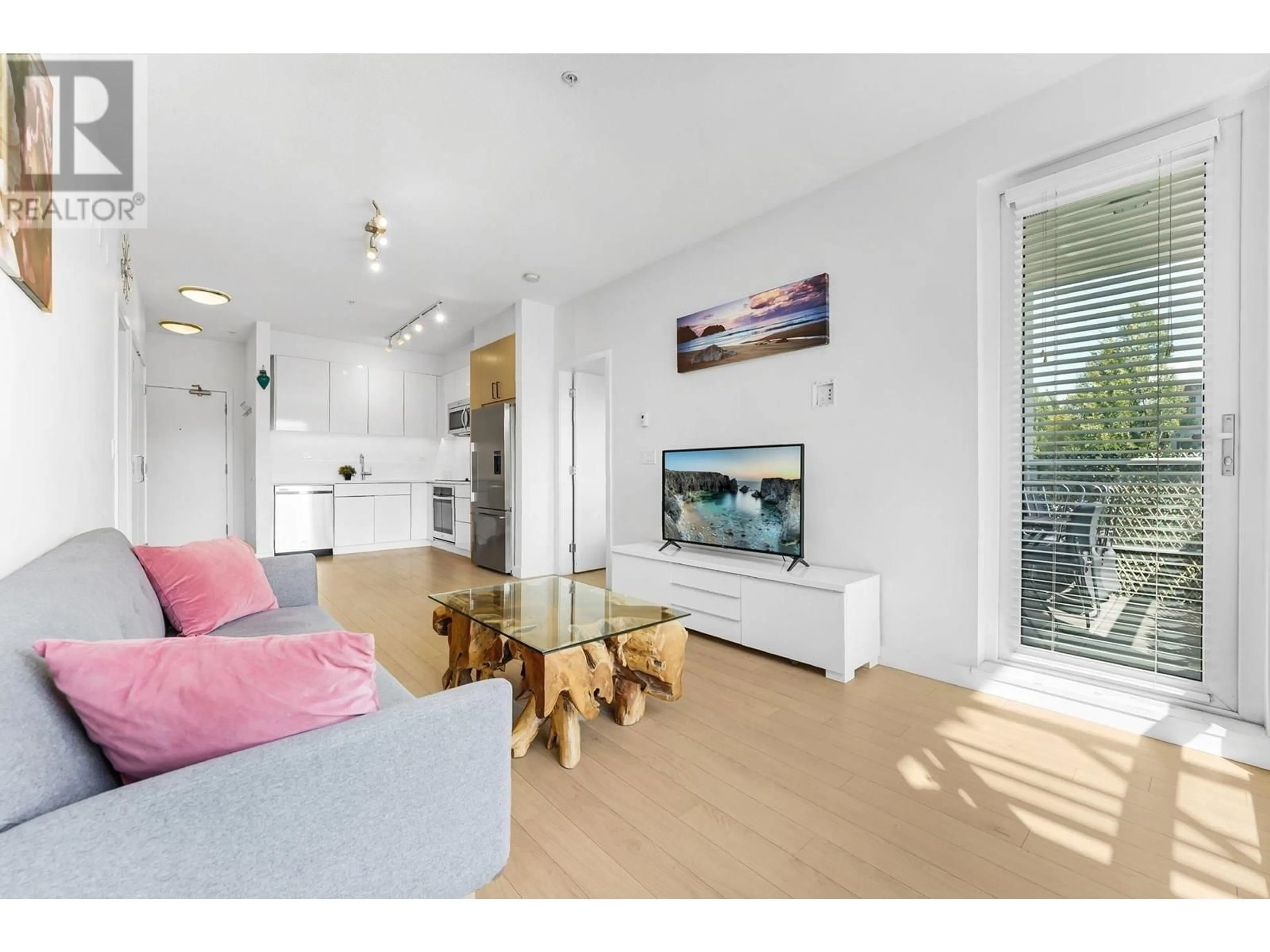 Living room with furniture, wood/laminate floor for 211 - 1621 HAMILTON AVENUE, North Vancouver British Columbia V7P0B6