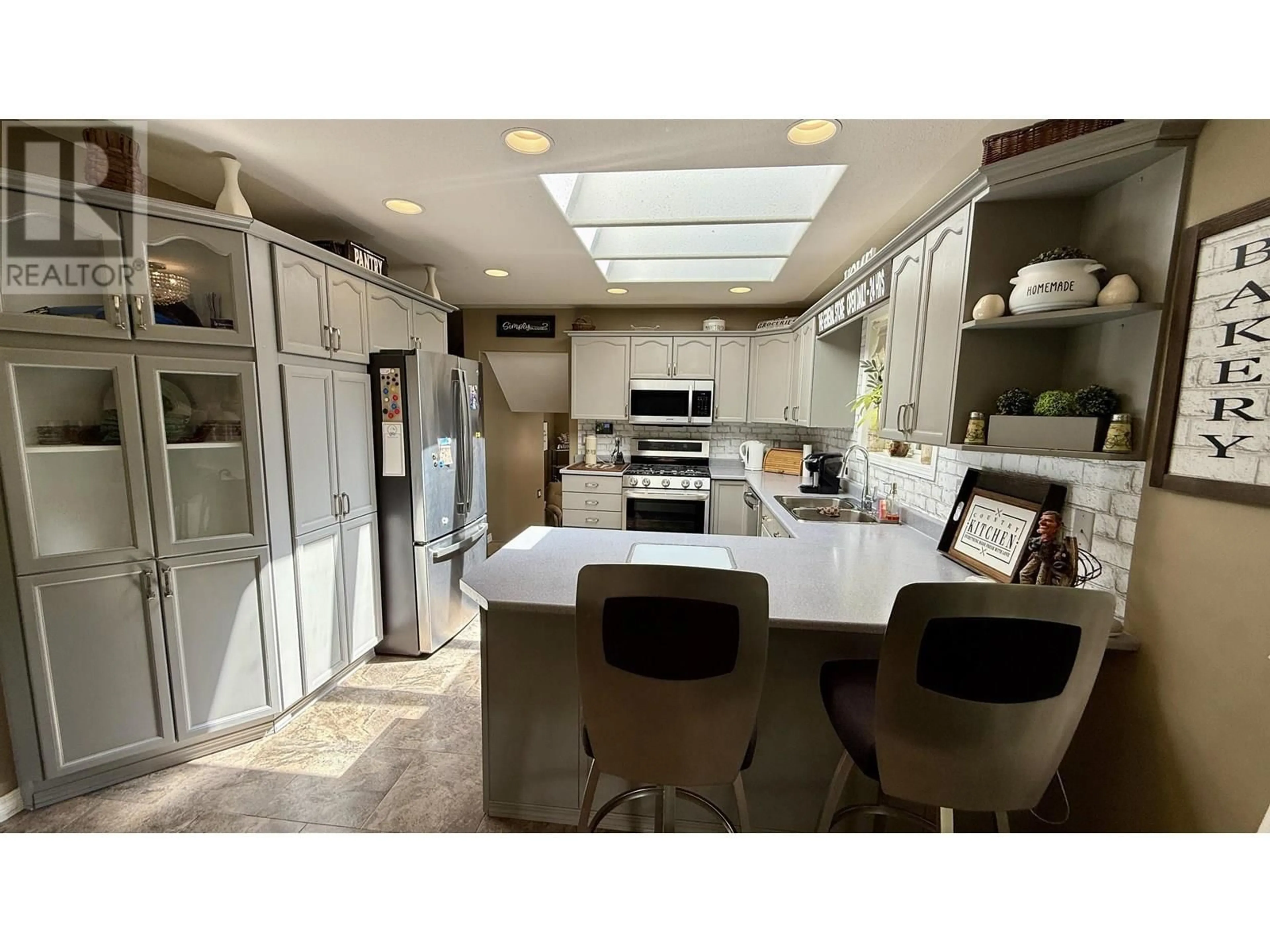 Open concept kitchen, ceramic/tile floor for 4887 MEESQUONO TRAIL, 108 Mile Ranch British Columbia V0K2Z0