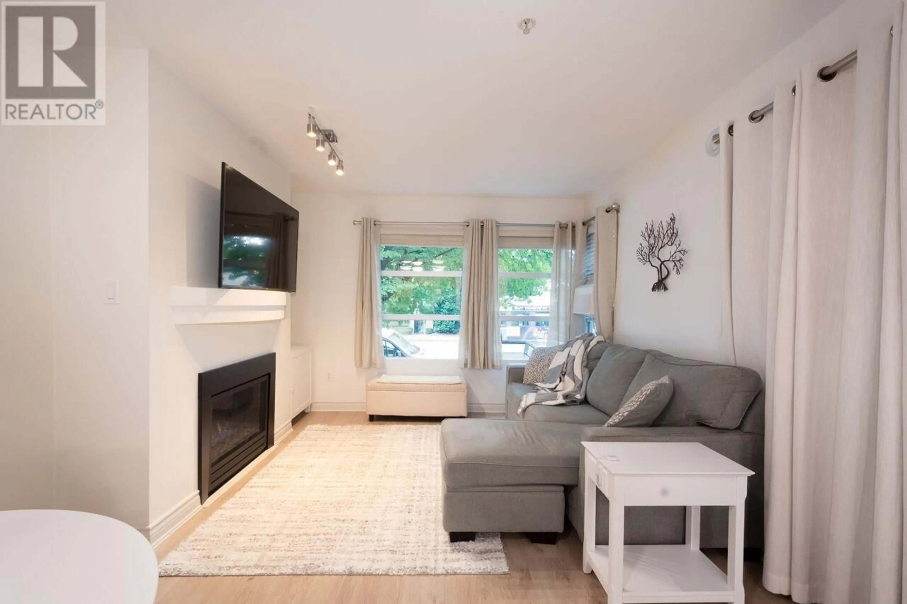 Living room with furniture, wood/laminate floor for 206 - 3083 4TH AVENUE, Vancouver British Columbia V6K1R5
