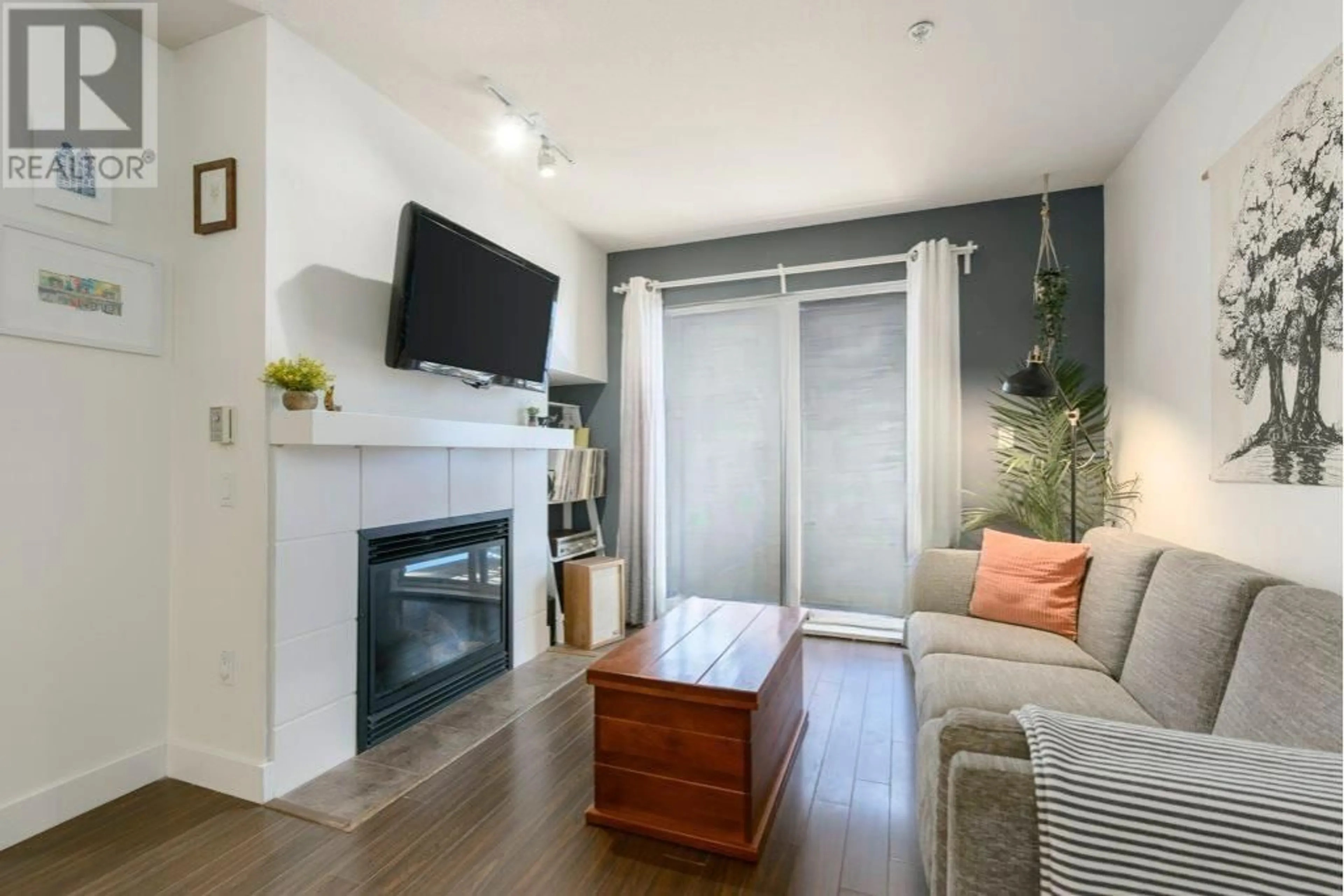 Living room with furniture, wood/laminate floor for 207 - 3240 ST JOHNS STREET, Port Moody British Columbia V3H0C1