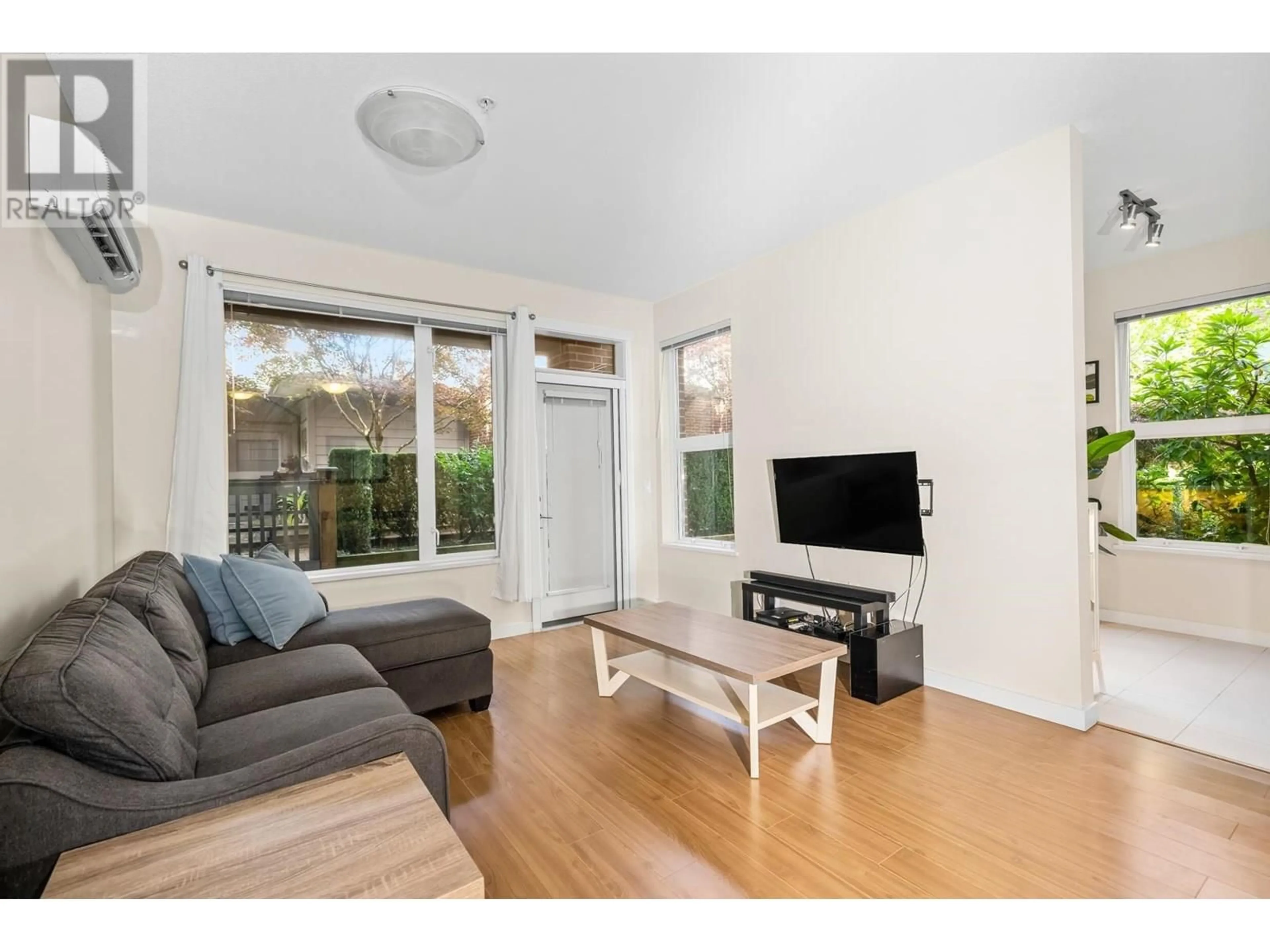 Living room with furniture, wood/laminate floor for 121 - 9399 ODLIN ROAD, Richmond British Columbia V6X0J6