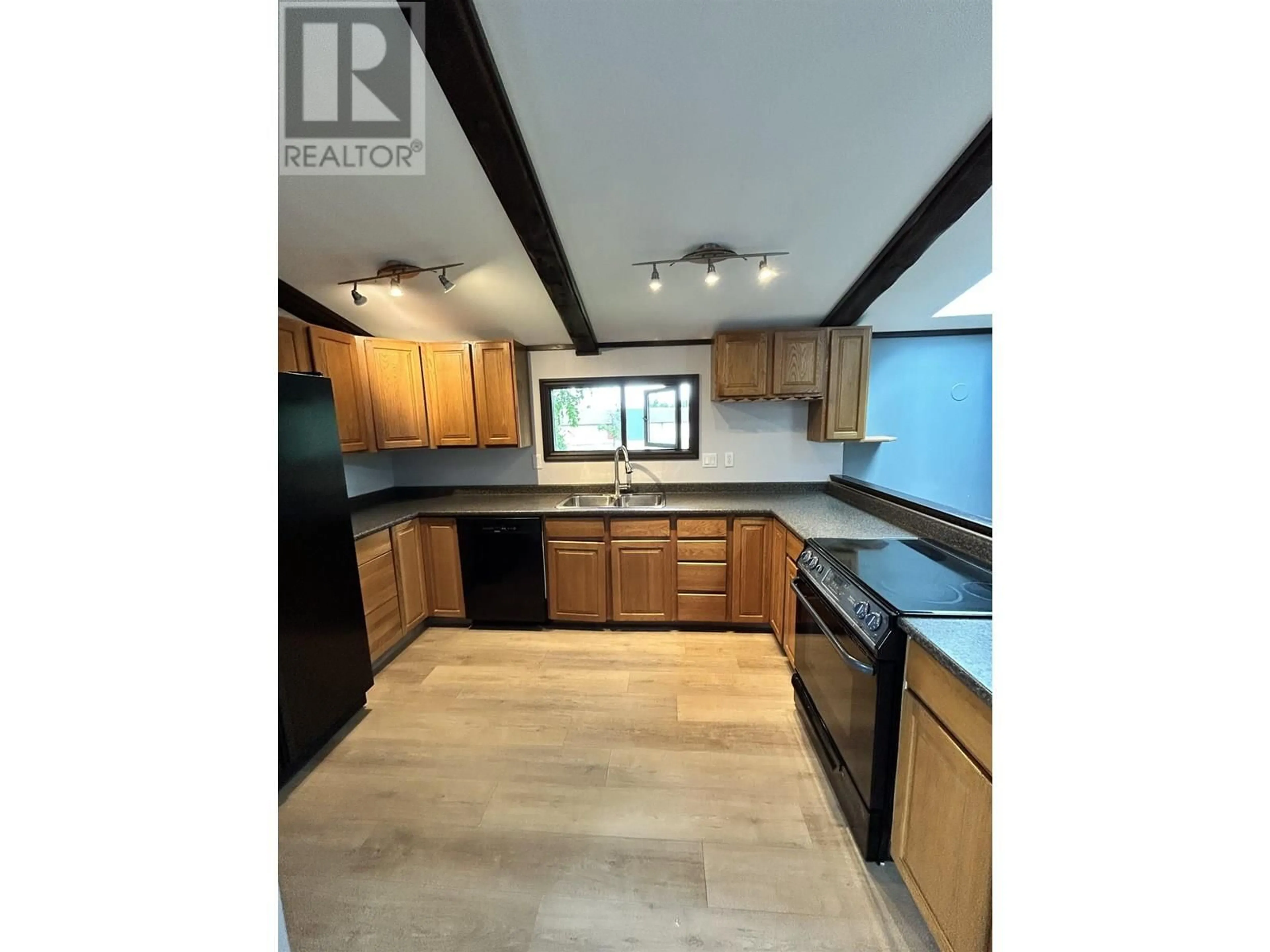 Open concept kitchen, wood/laminate floor for 7974 LOYOLA CRESCENT, Prince George British Columbia V2N3V4