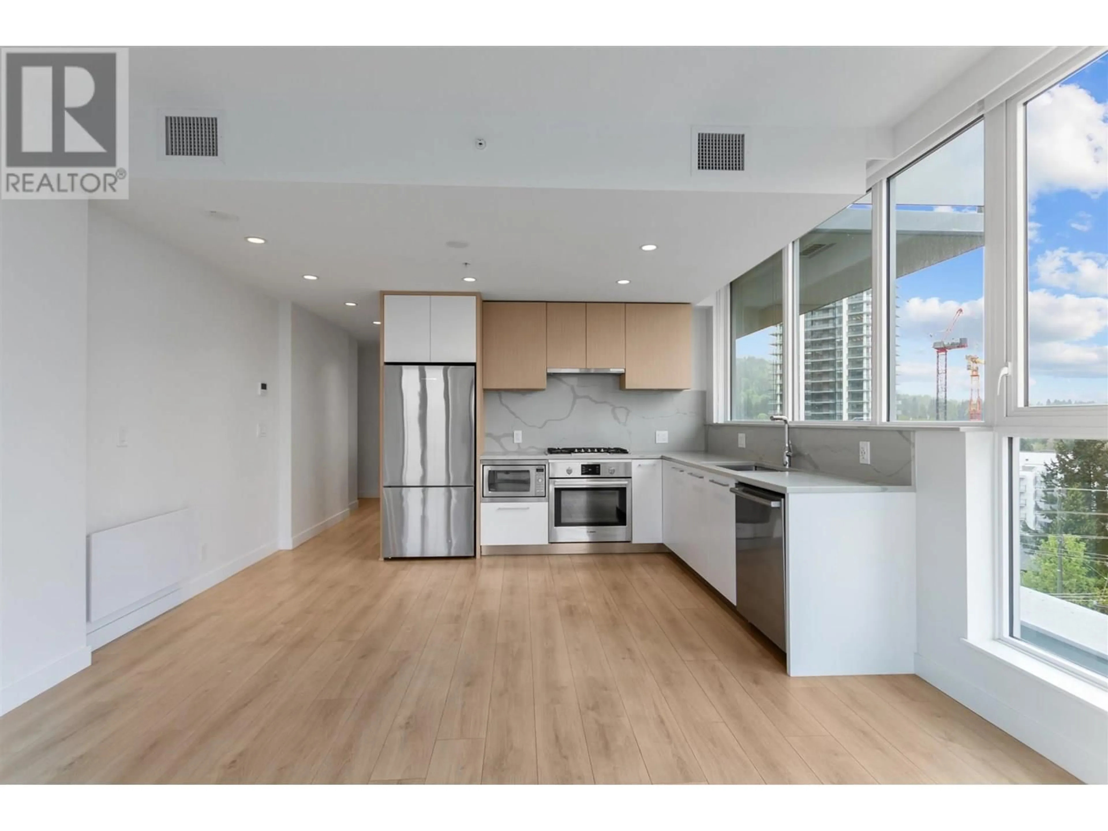 Open concept kitchen, wood/laminate floor for 707 - 567 CLARKE ROAD, Coquitlam British Columbia V3J0K7