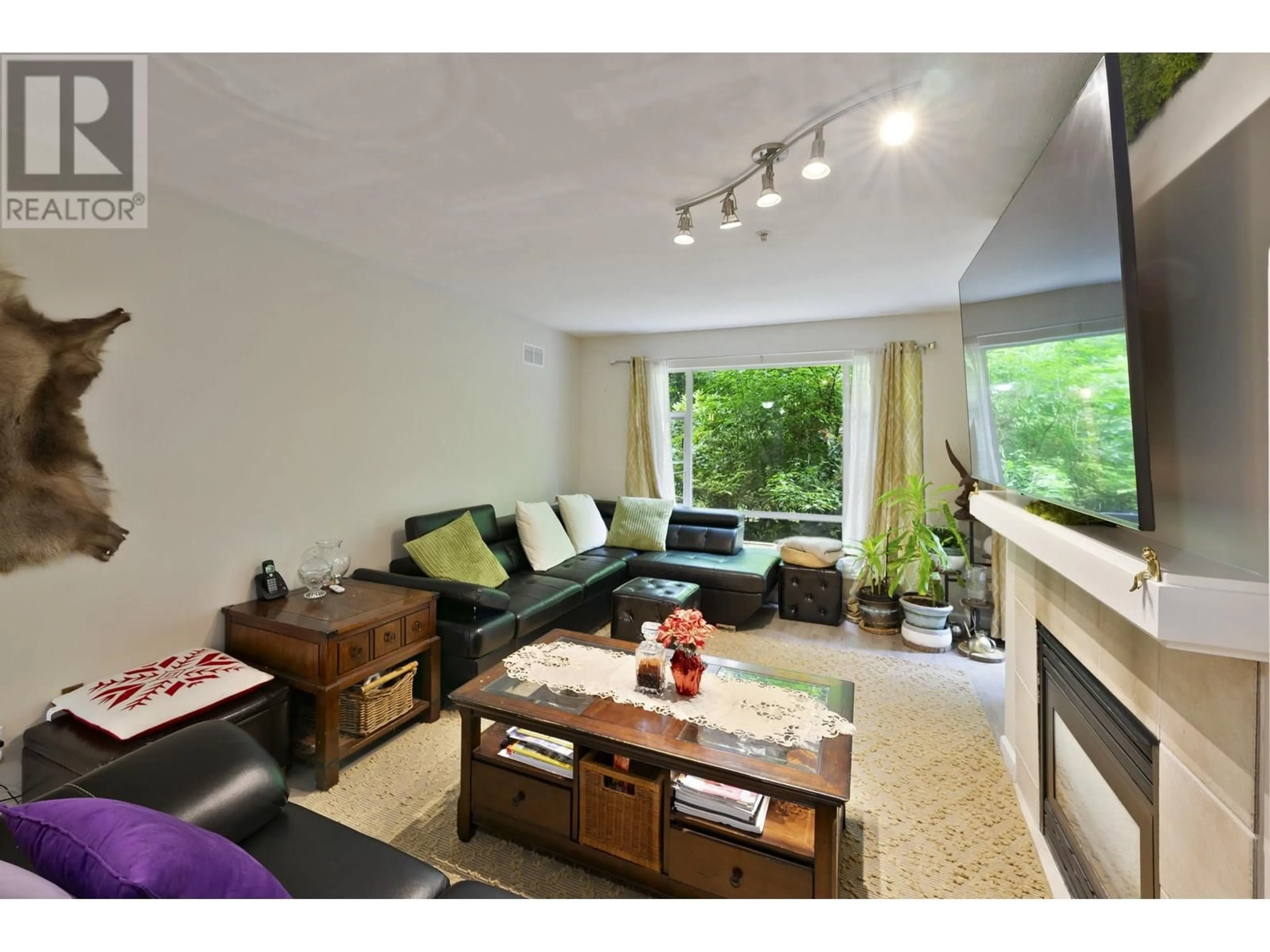 Living room with furniture, wood/laminate floor for 204 - 22233 RIVER ROAD, Maple Ridge British Columbia V2X3N7
