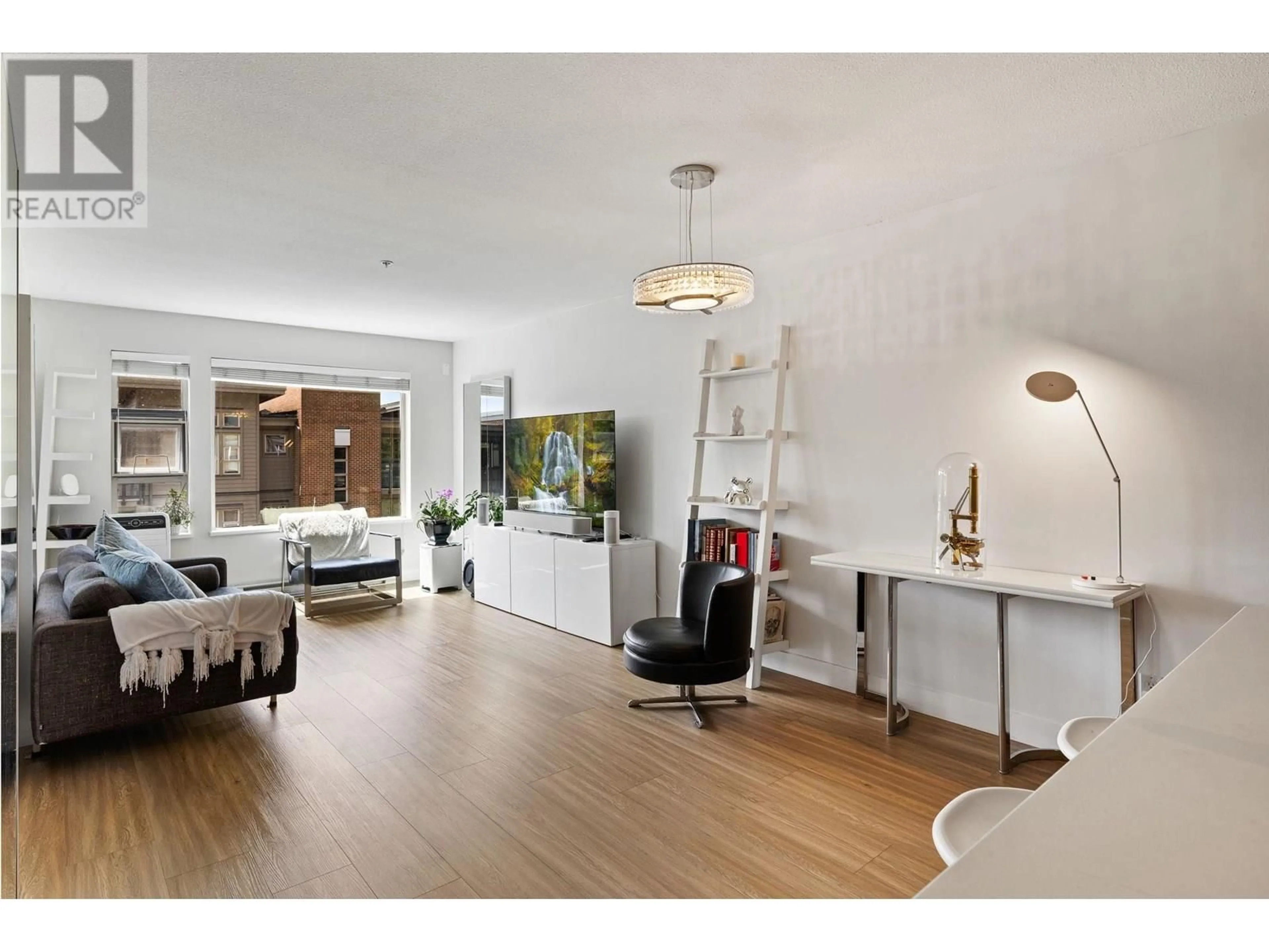 Living room with furniture, wood/laminate floor for 412 - 1679 LLOYD AVENUE, North Vancouver British Columbia V7P0A9