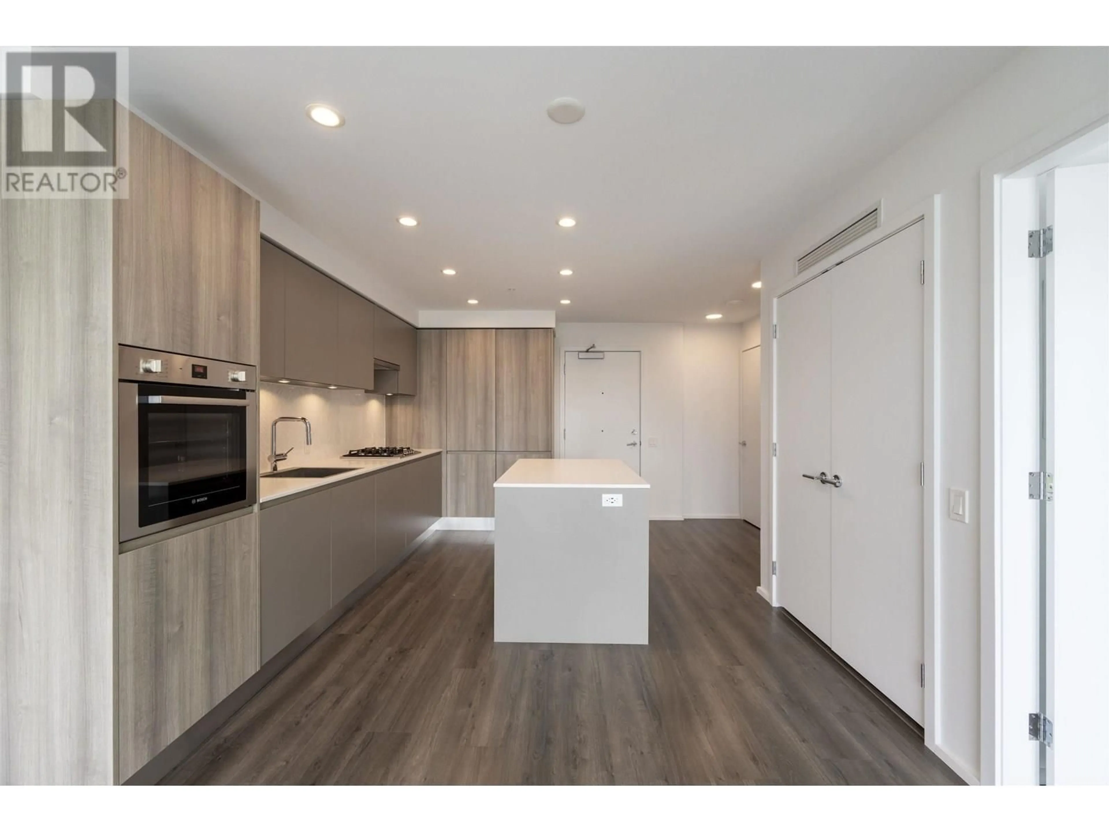 Open concept kitchen, wood/laminate floor for 410 - 3809 EVERGREEN PLACE, Burnaby British Columbia V3J0M1