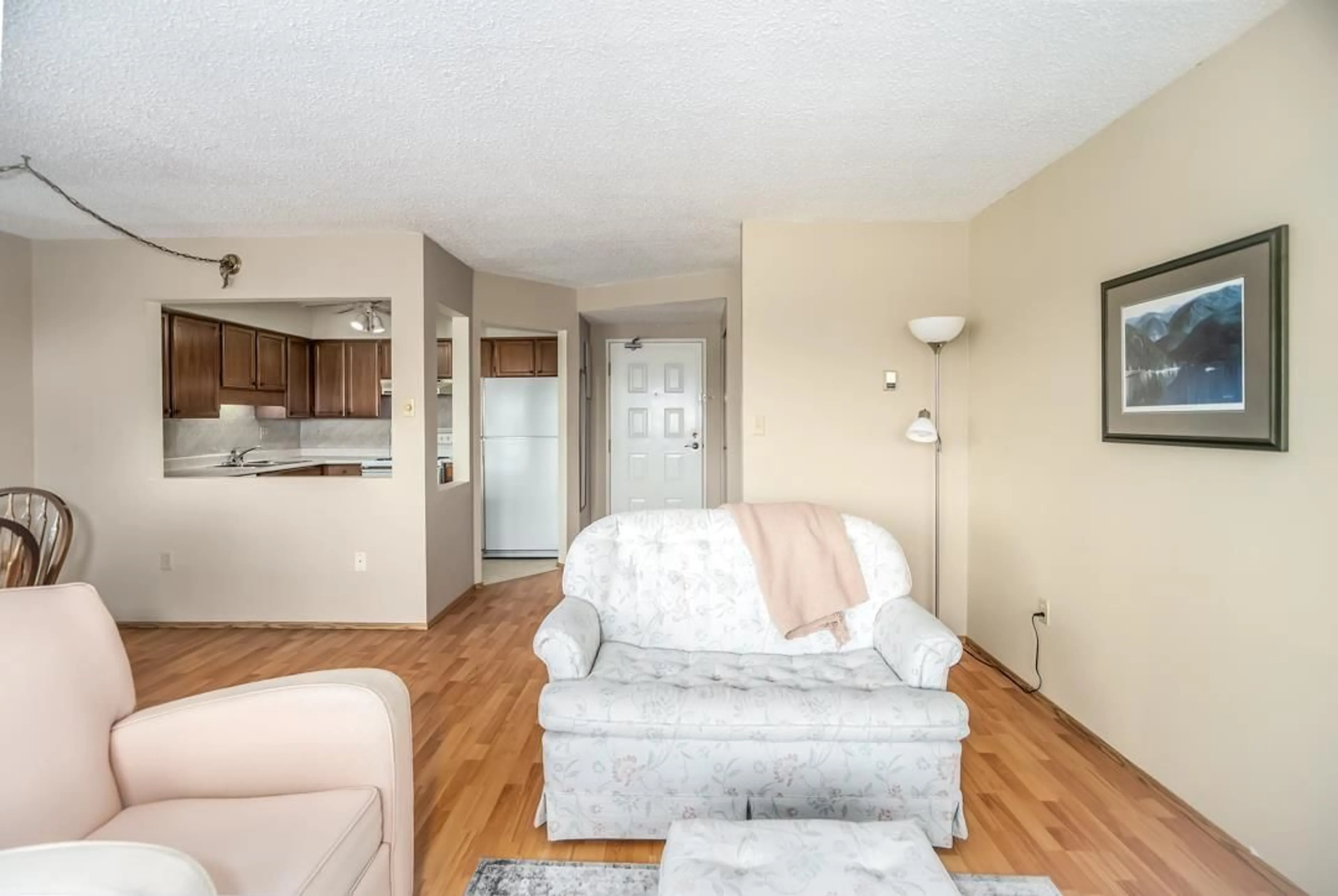 Living room with furniture, wood/laminate floor for 604 - 31955 OLD YALE, Abbotsford British Columbia V2T4N1