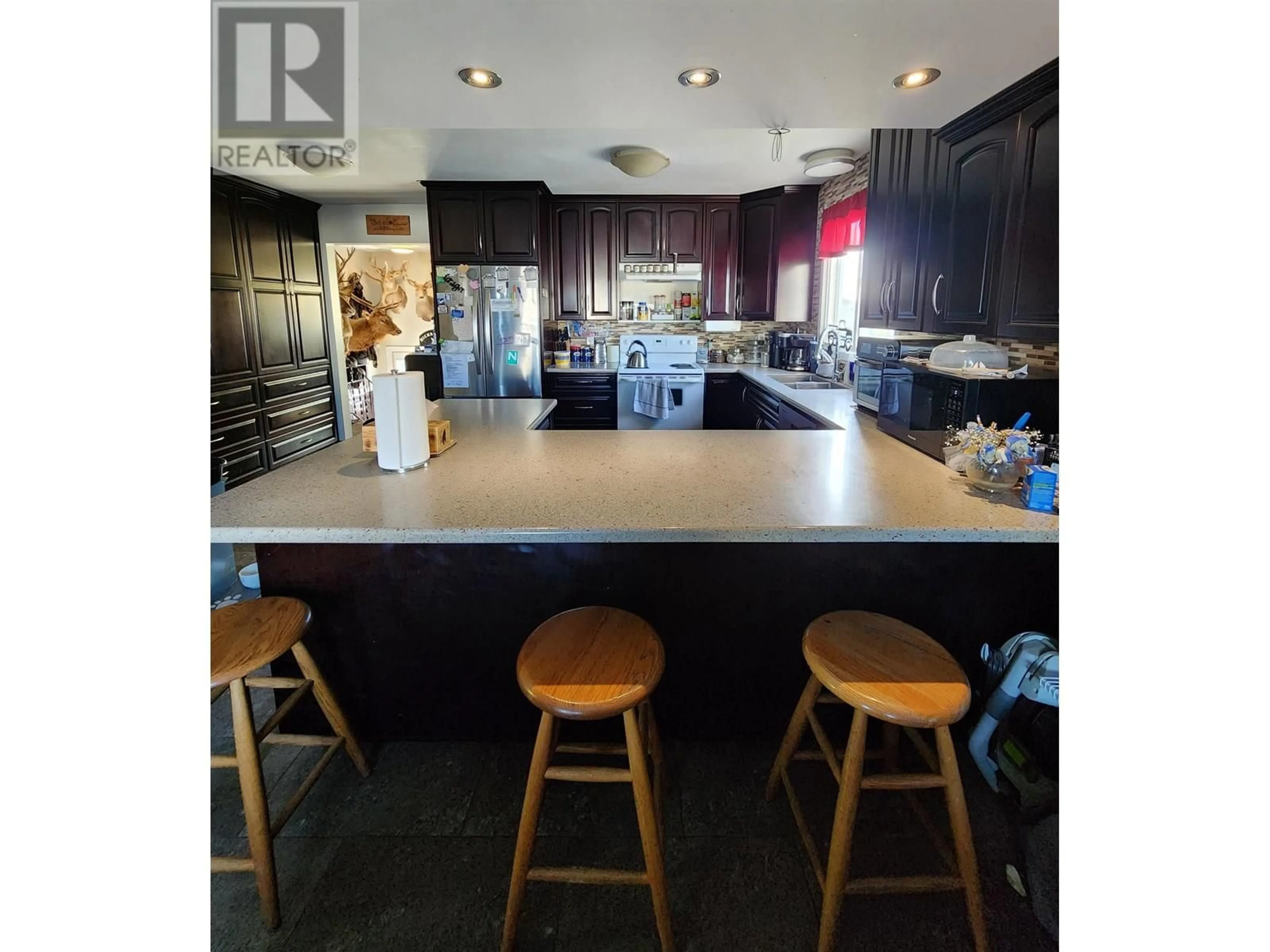 Open concept kitchen, wood/laminate floor for 11015 102 STREET, Fort St. John British Columbia V1J4C2
