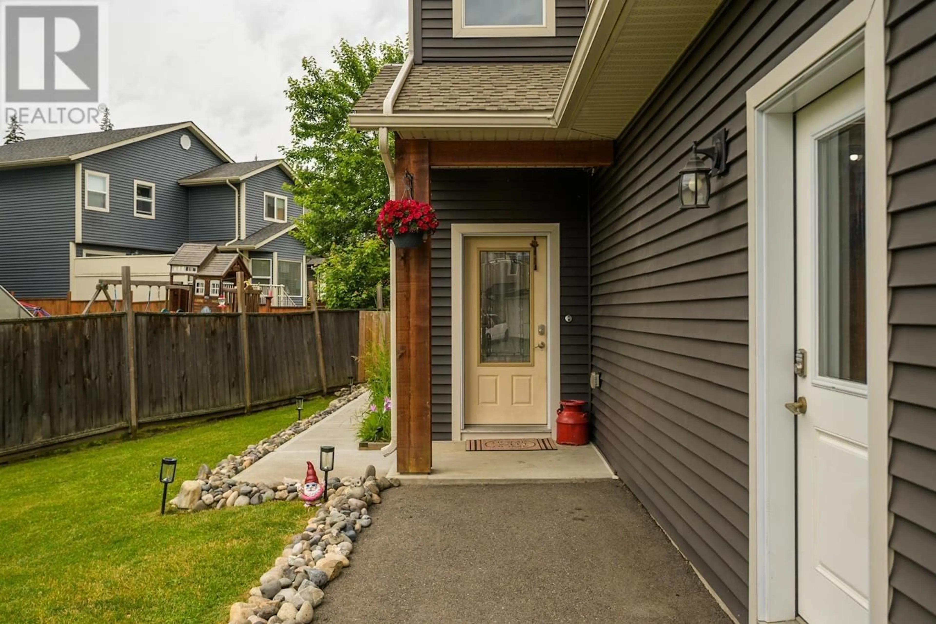 Home with vinyl exterior material, street for 7677 CREEKSIDE WAY, Prince George British Columbia V2N0C2