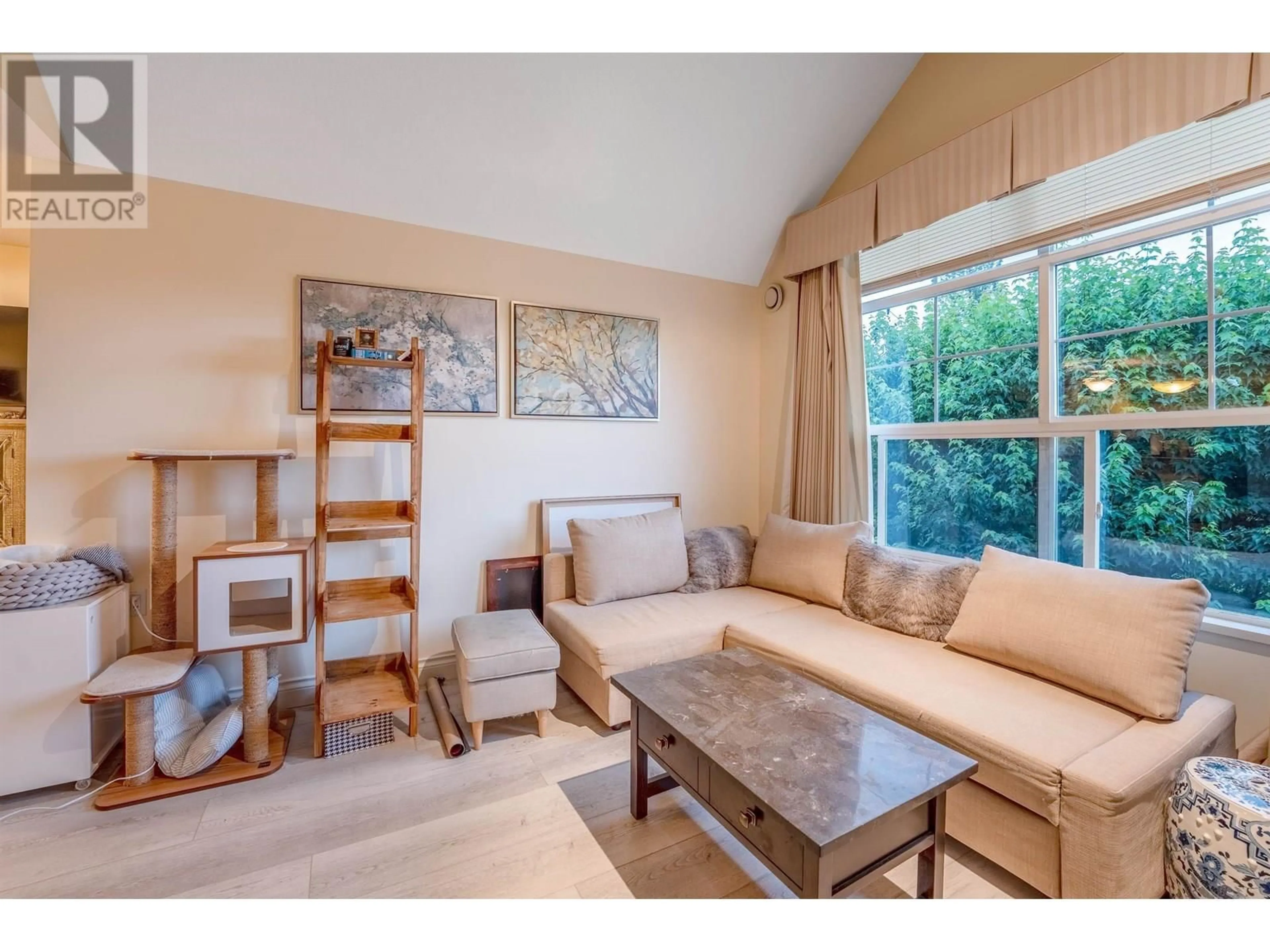 Living room with furniture, wood/laminate floor for 416 - 960 LYNN VALLEY ROAD, North Vancouver British Columbia V7J3V6
