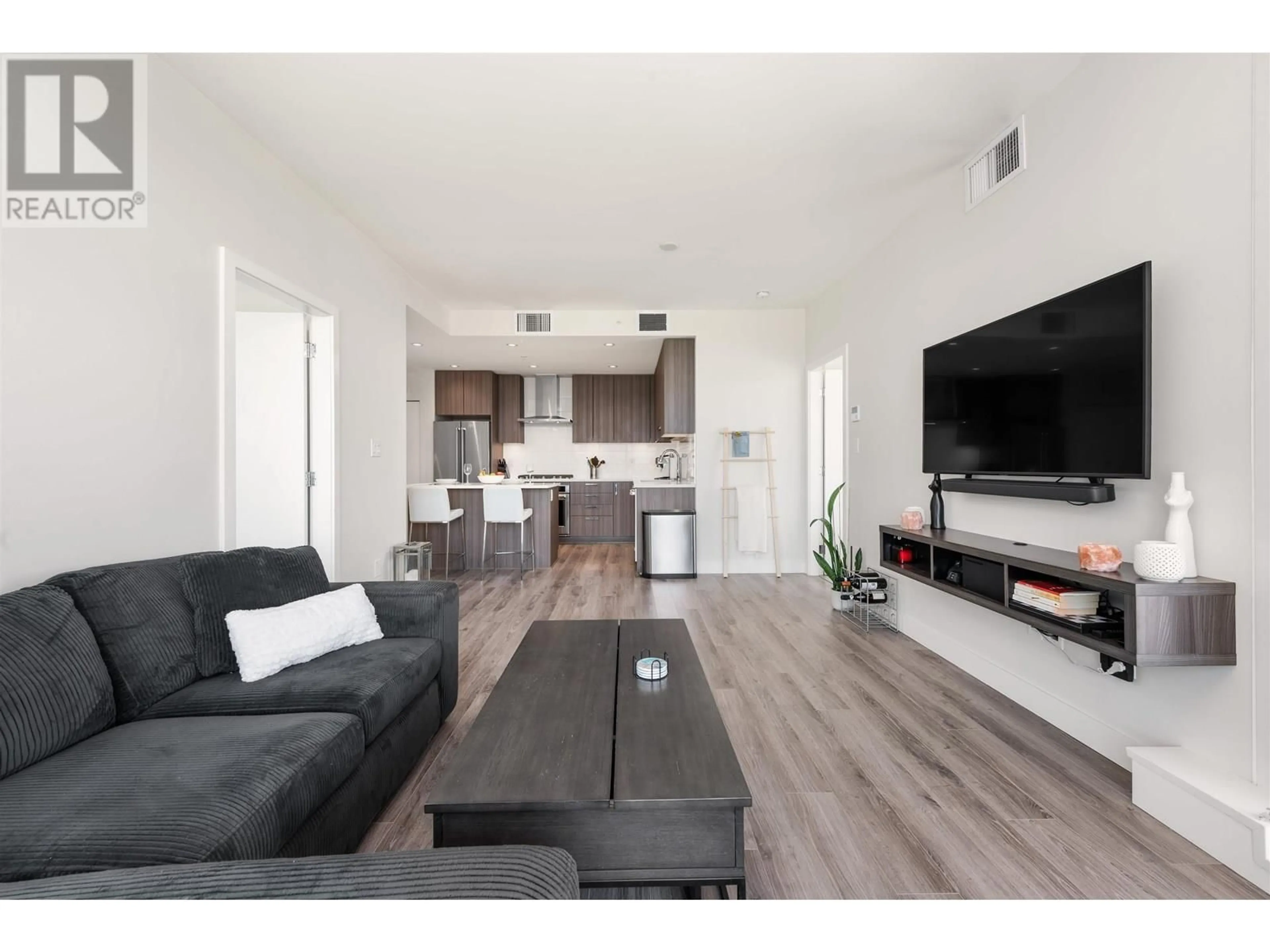 Living room with furniture, wood/laminate floor for 2408 - 1788 GILMORE AVENUE, Burnaby British Columbia V5C0L5