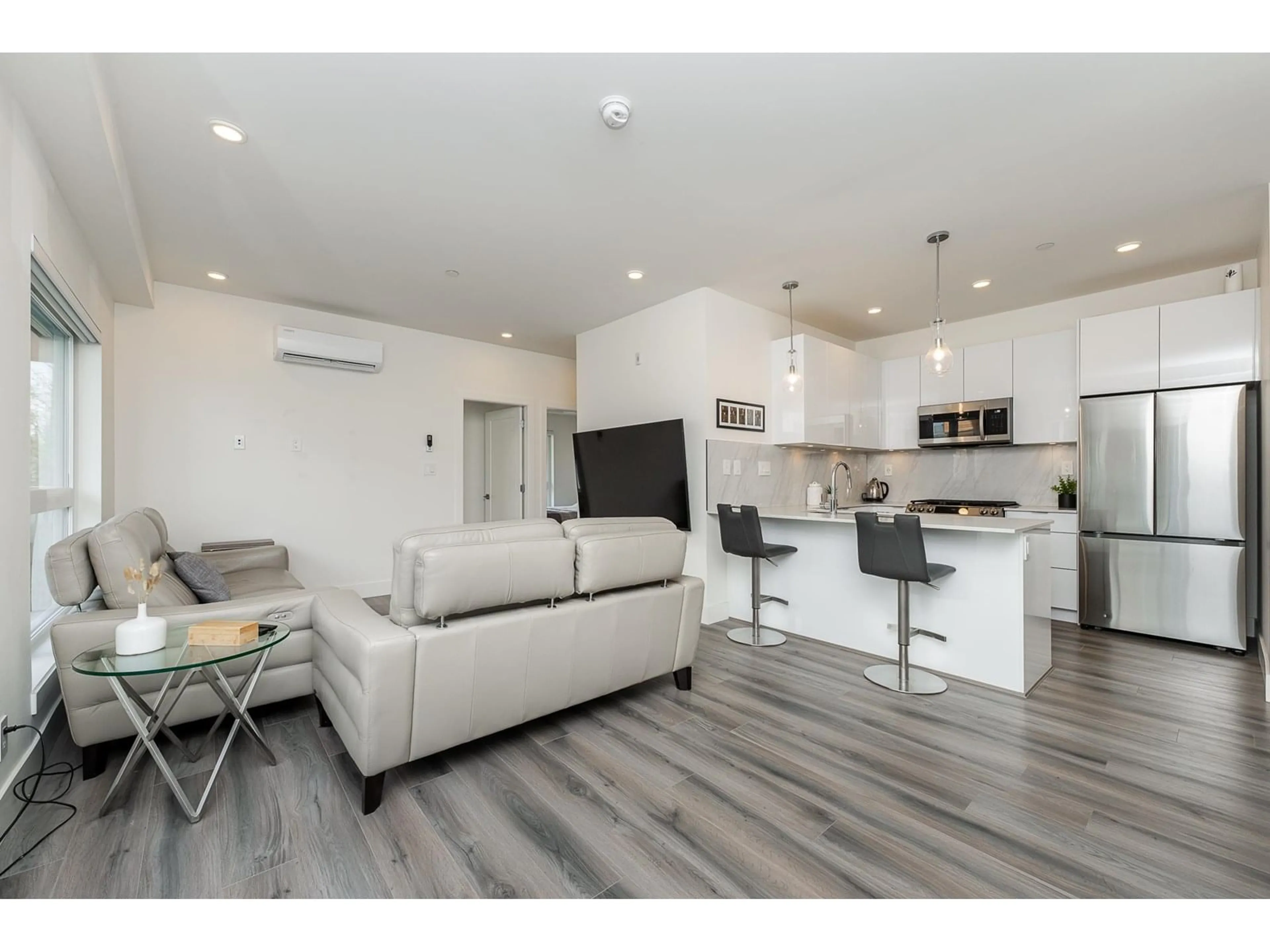 Open concept kitchen, wood/laminate floor for A303 - 8447 202, Langley British Columbia V2Y2B7
