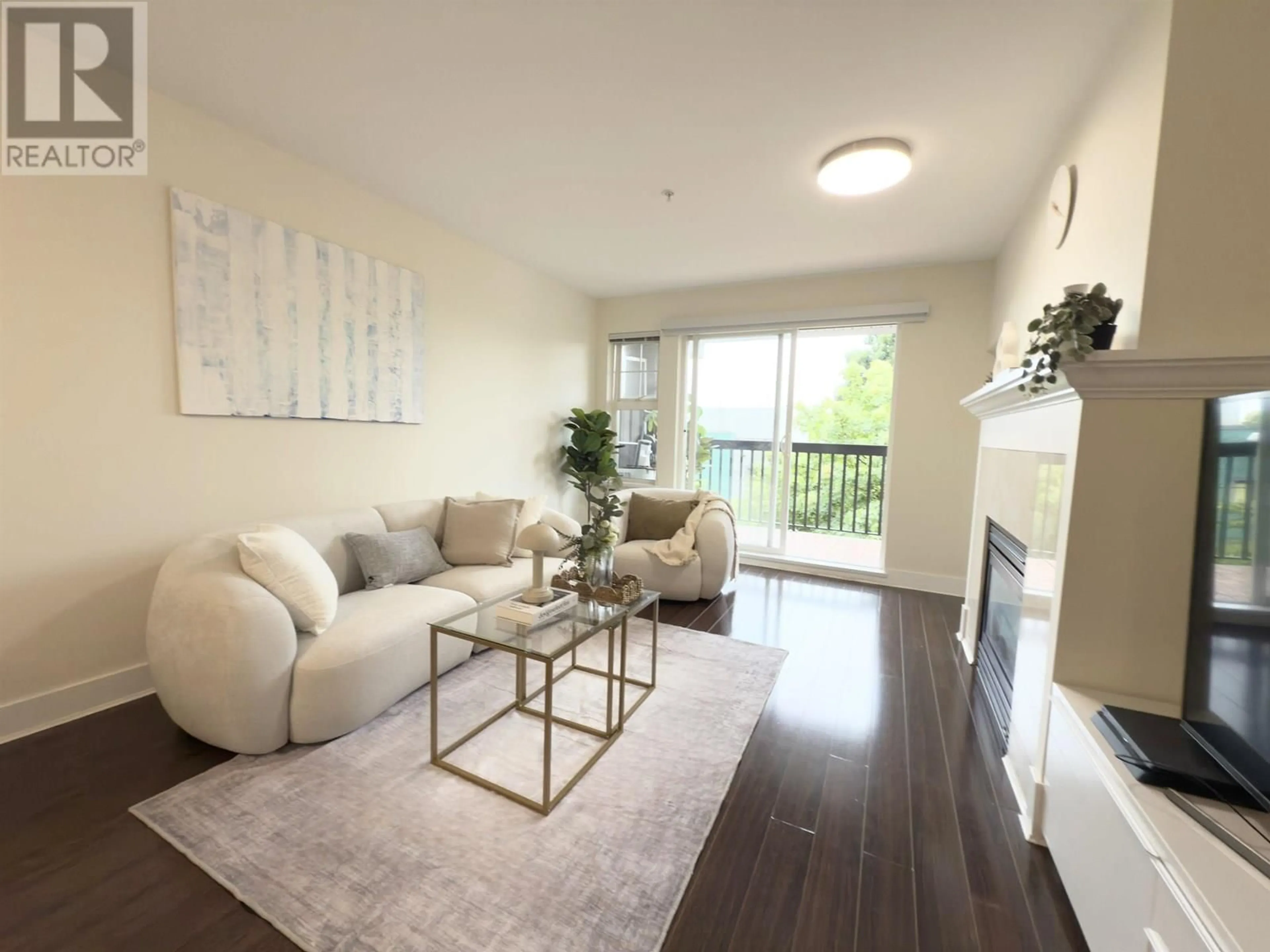 Living room with furniture, wood/laminate floor for 312 - 995 59TH AVENUE, Vancouver British Columbia V6P6Z2