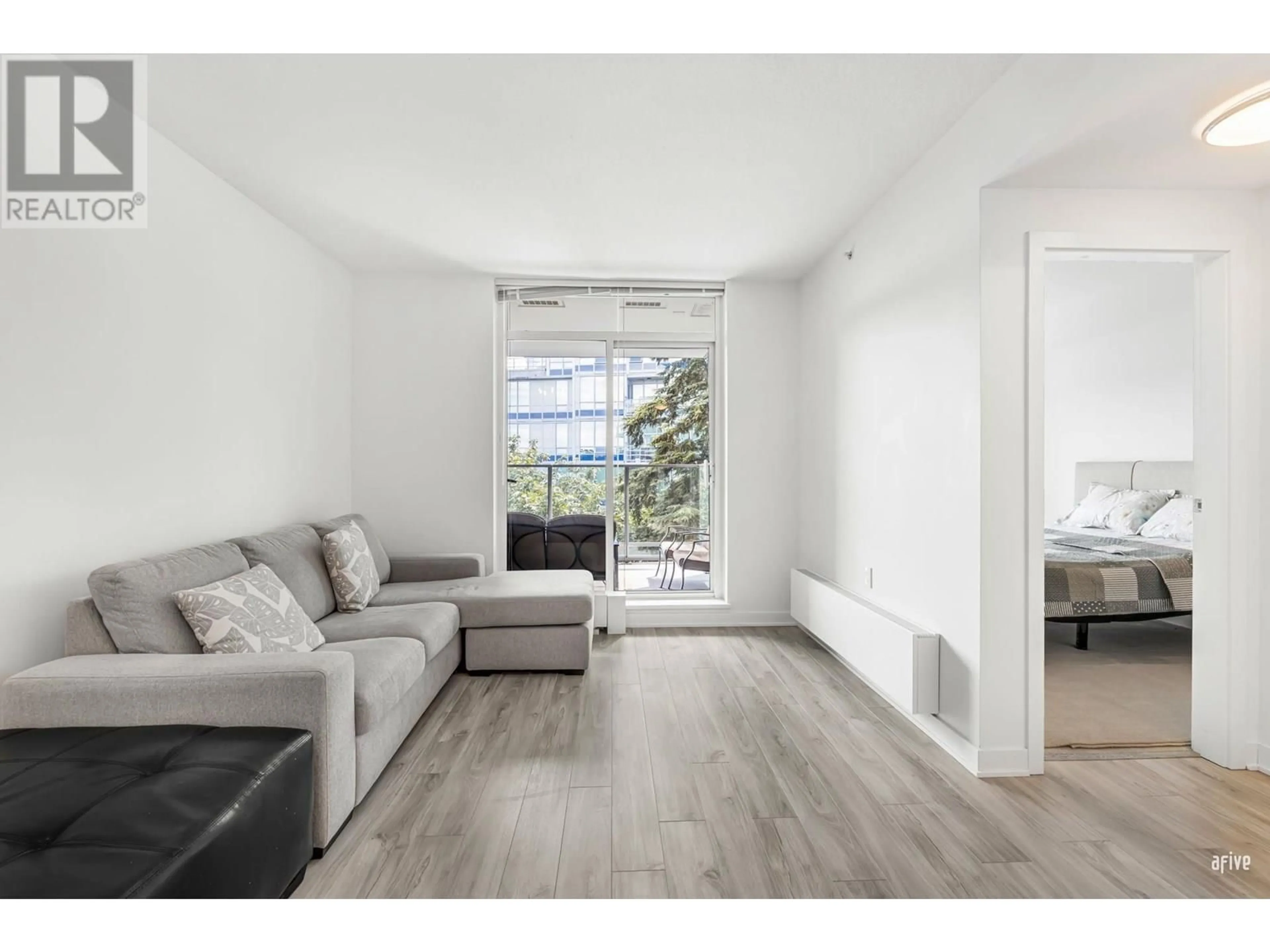 Living room with furniture, wood/laminate floor for 908 - 8940 UNIVERSITY CRESCENT, Burnaby British Columbia V5A4Y8