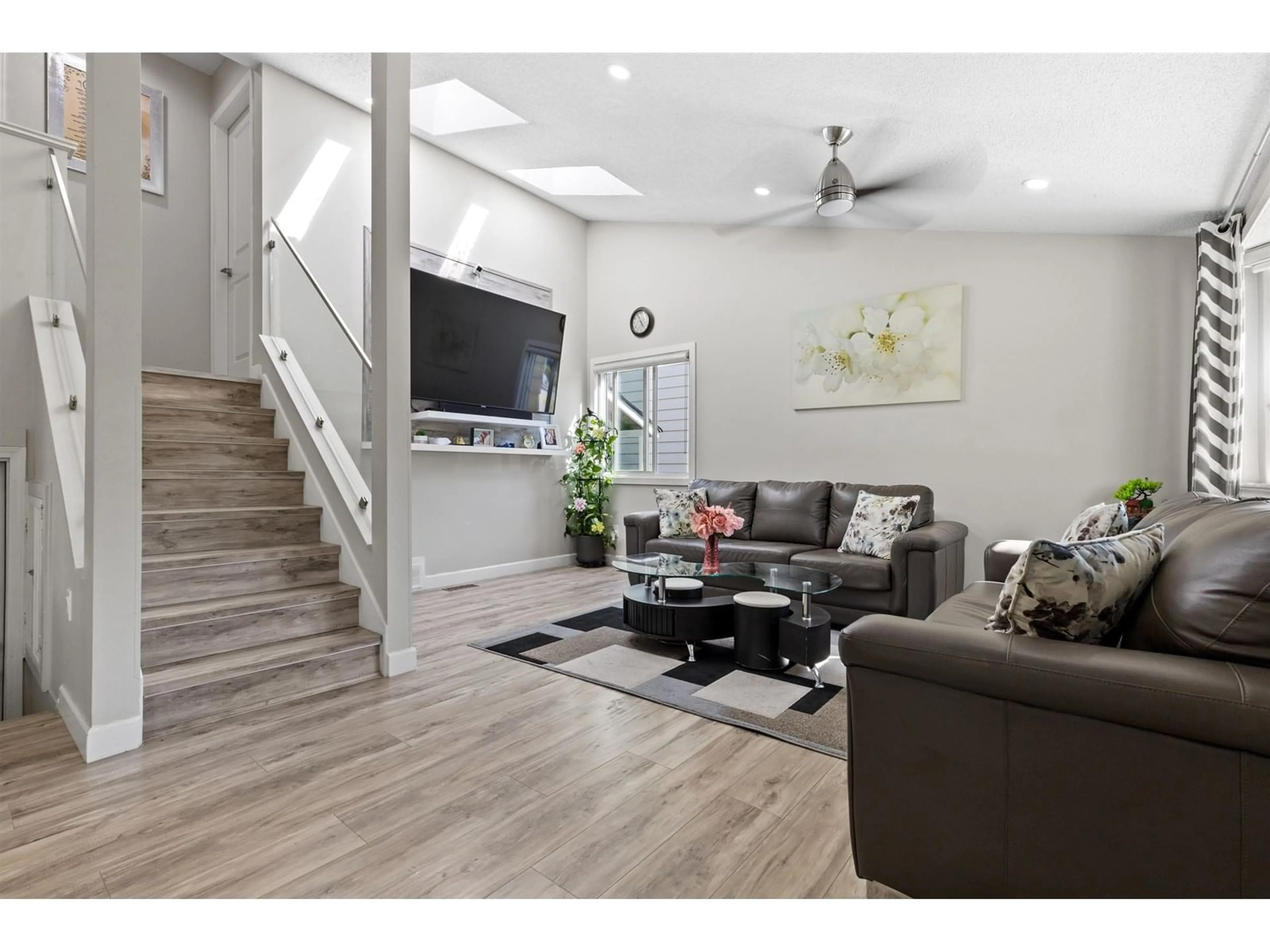 Living room with furniture, wood/laminate floor for 7294 129B, Surrey British Columbia V3W6Z8