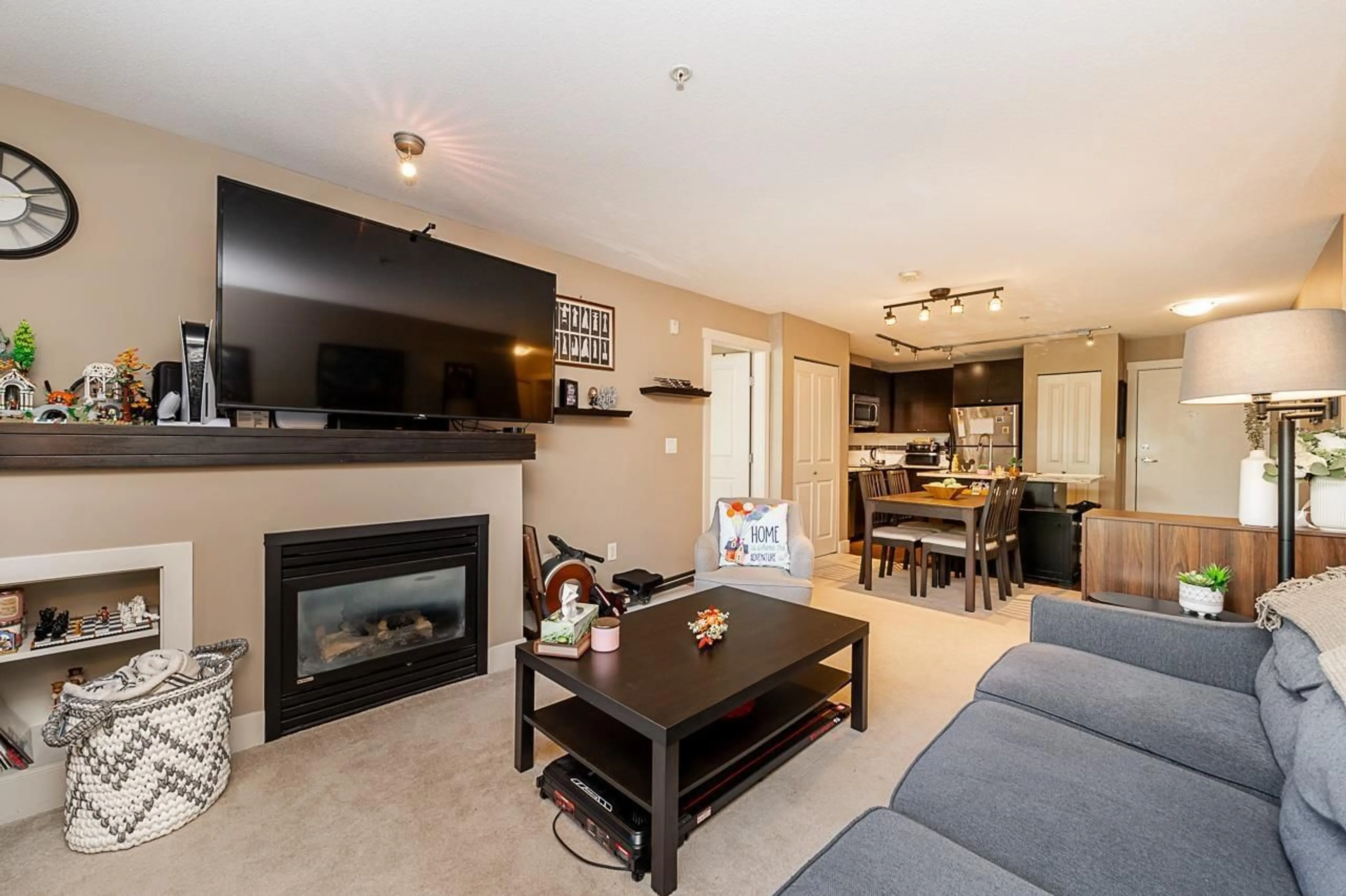 Living room with furniture, wood/laminate floor for 201 - 6500 194, Surrey British Columbia V4N5X4