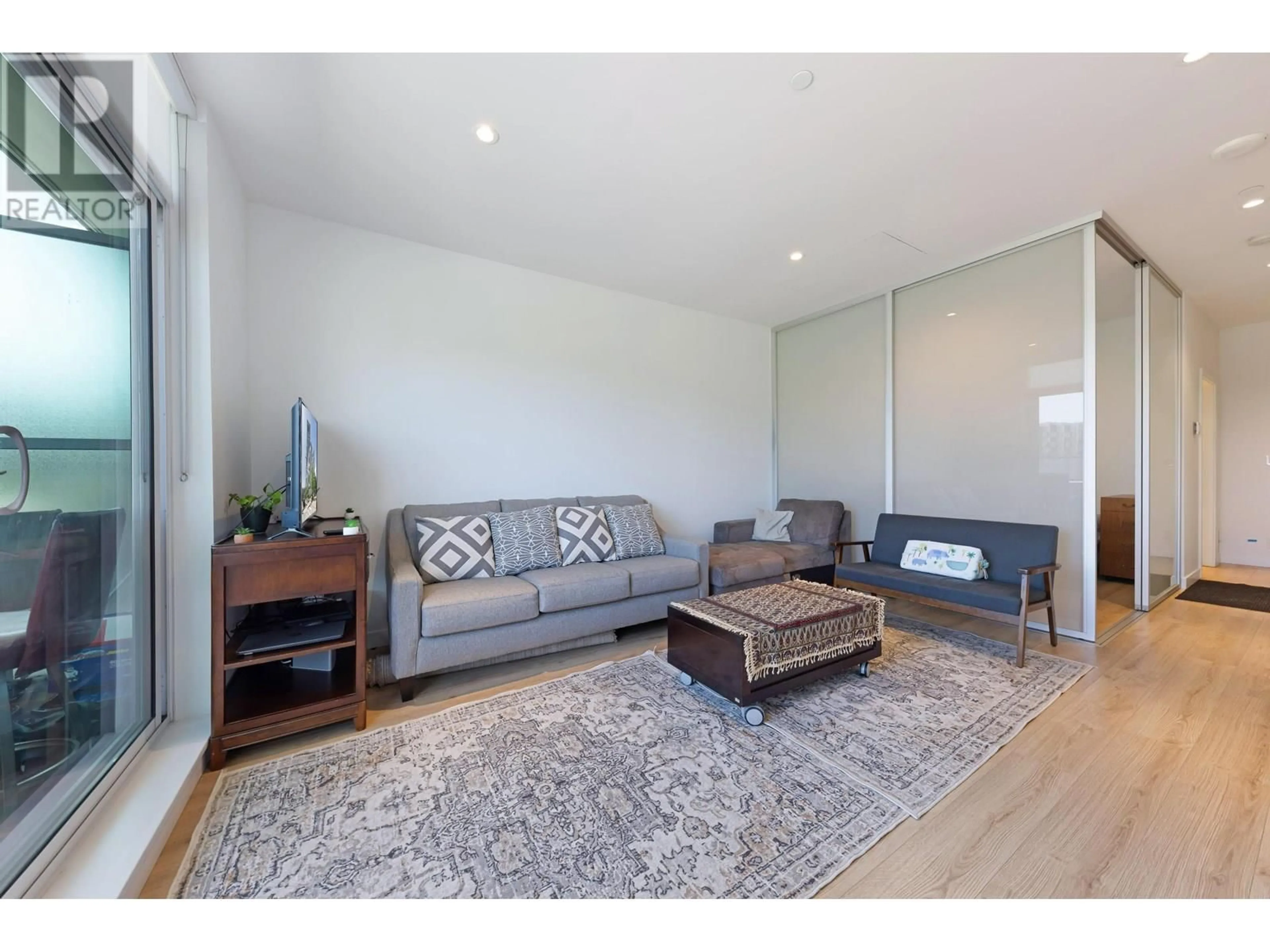 Living room with furniture, wood/laminate floor for 202 - 1500 FERN STREET, North Vancouver British Columbia V7J1H6