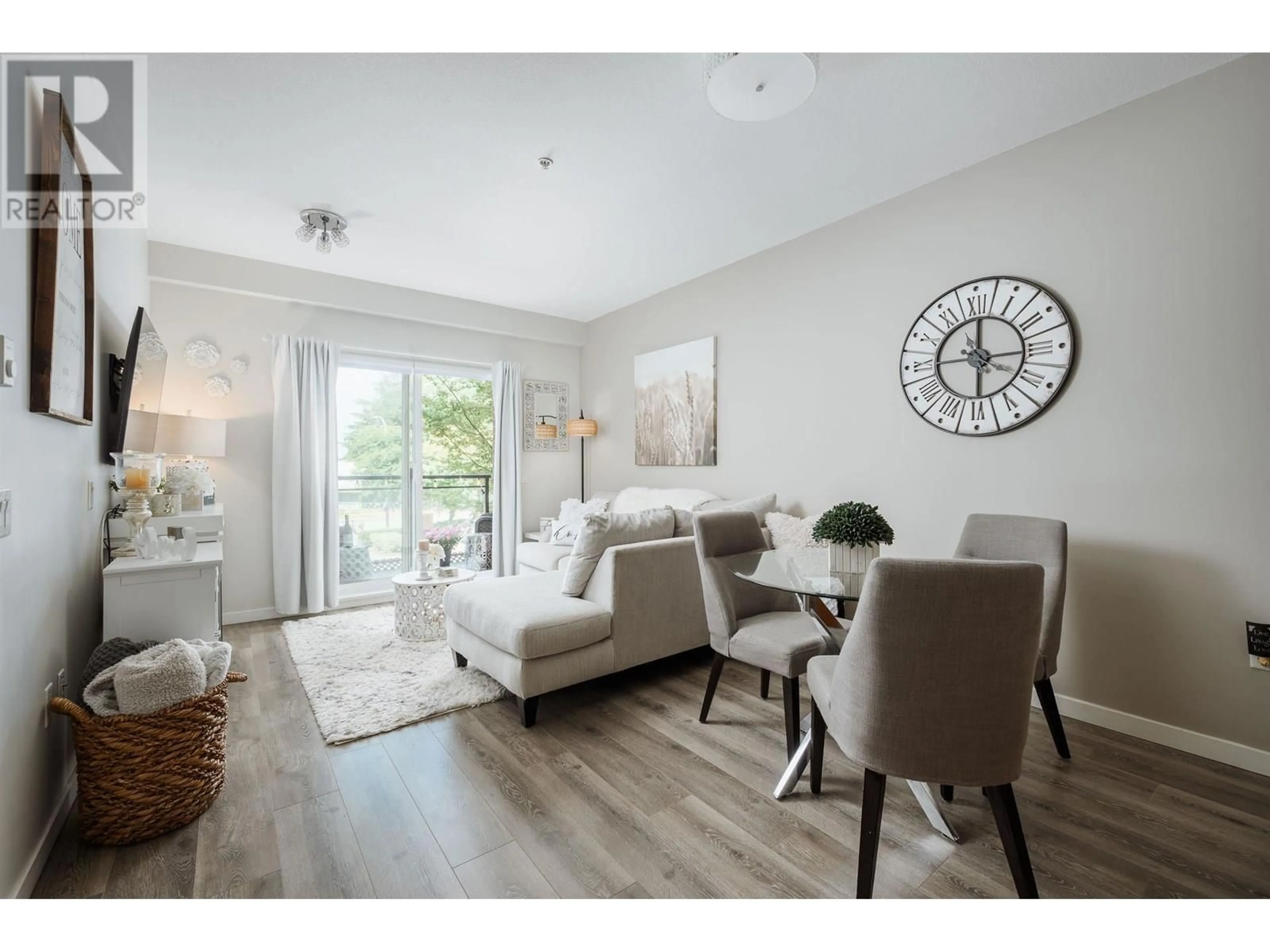 Living room with furniture, wood/laminate floor for 215 - 11950 HARRIS ROAD, Pitt Meadows British Columbia V3Y0B7