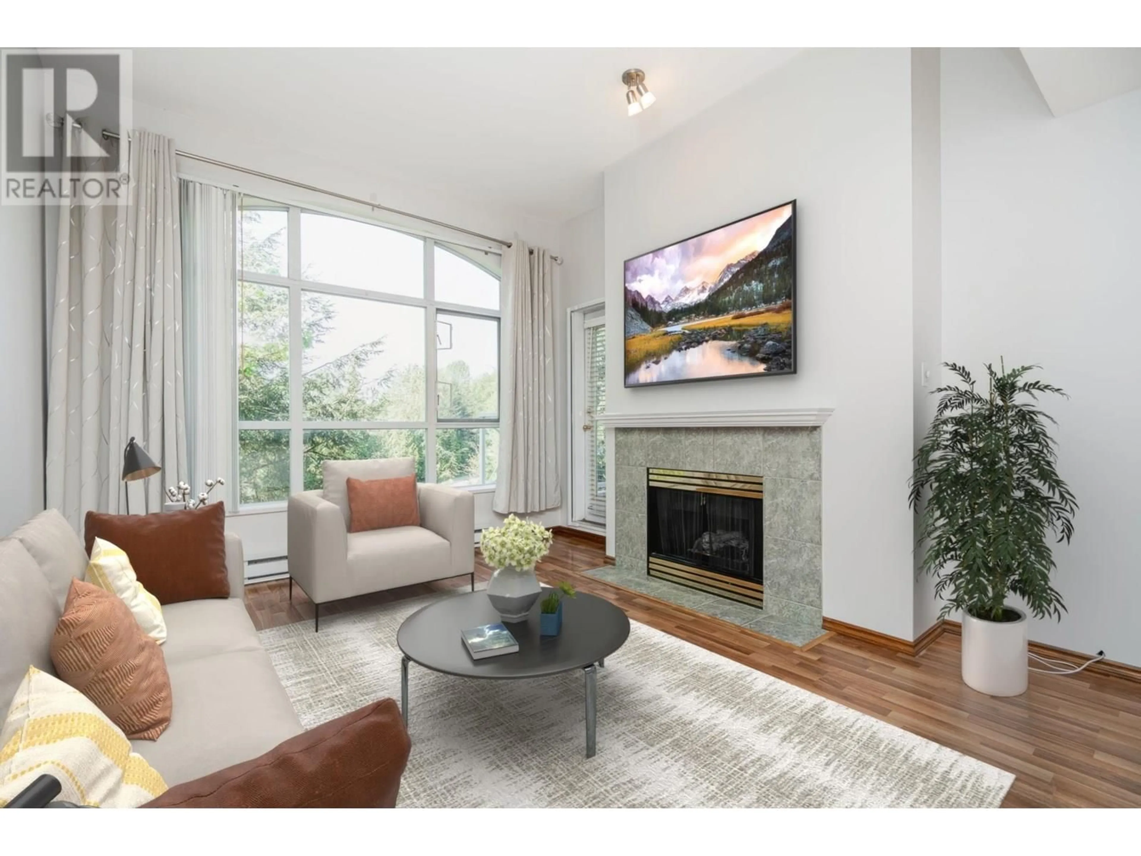 Living room with furniture, wood/laminate floor for 403 - 2559 PARKVIEW LANE, Port Coquitlam British Columbia V3C6M1