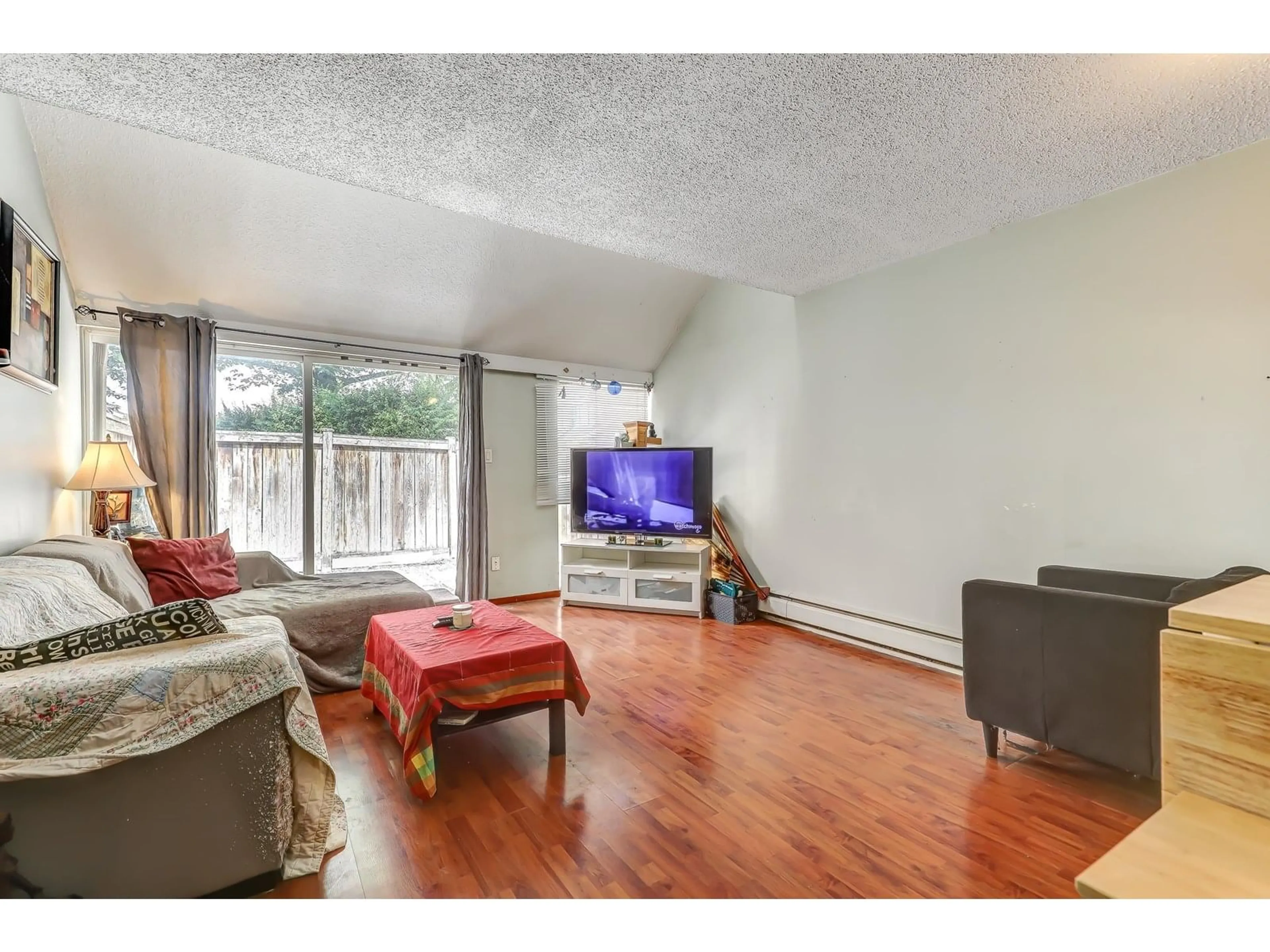 Living room with furniture, wood/laminate floor for 26 - 17702 60, Surrey British Columbia V3S1V2