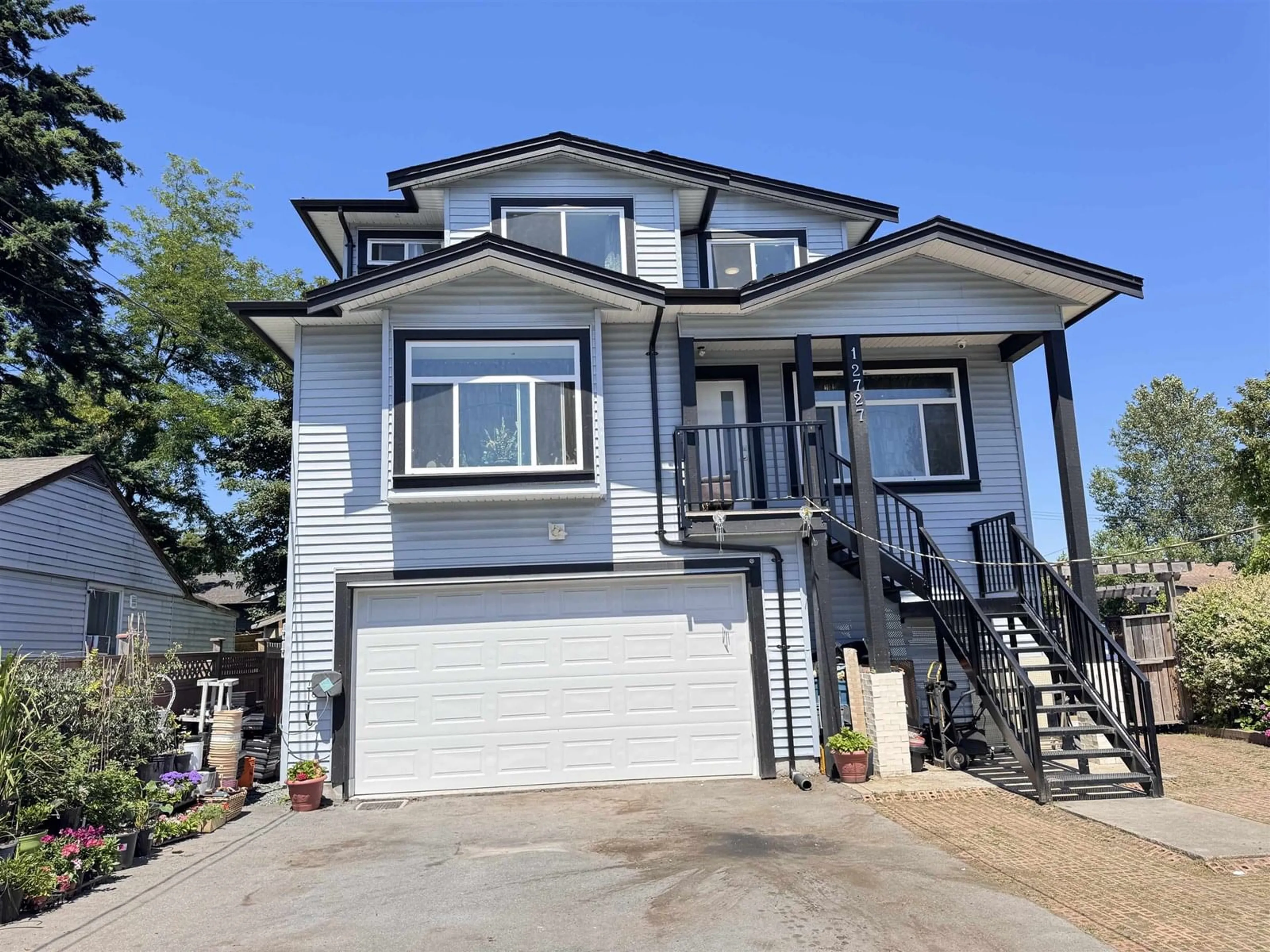 Home with vinyl exterior material, street for 12727 115A, Surrey British Columbia V3V4V5