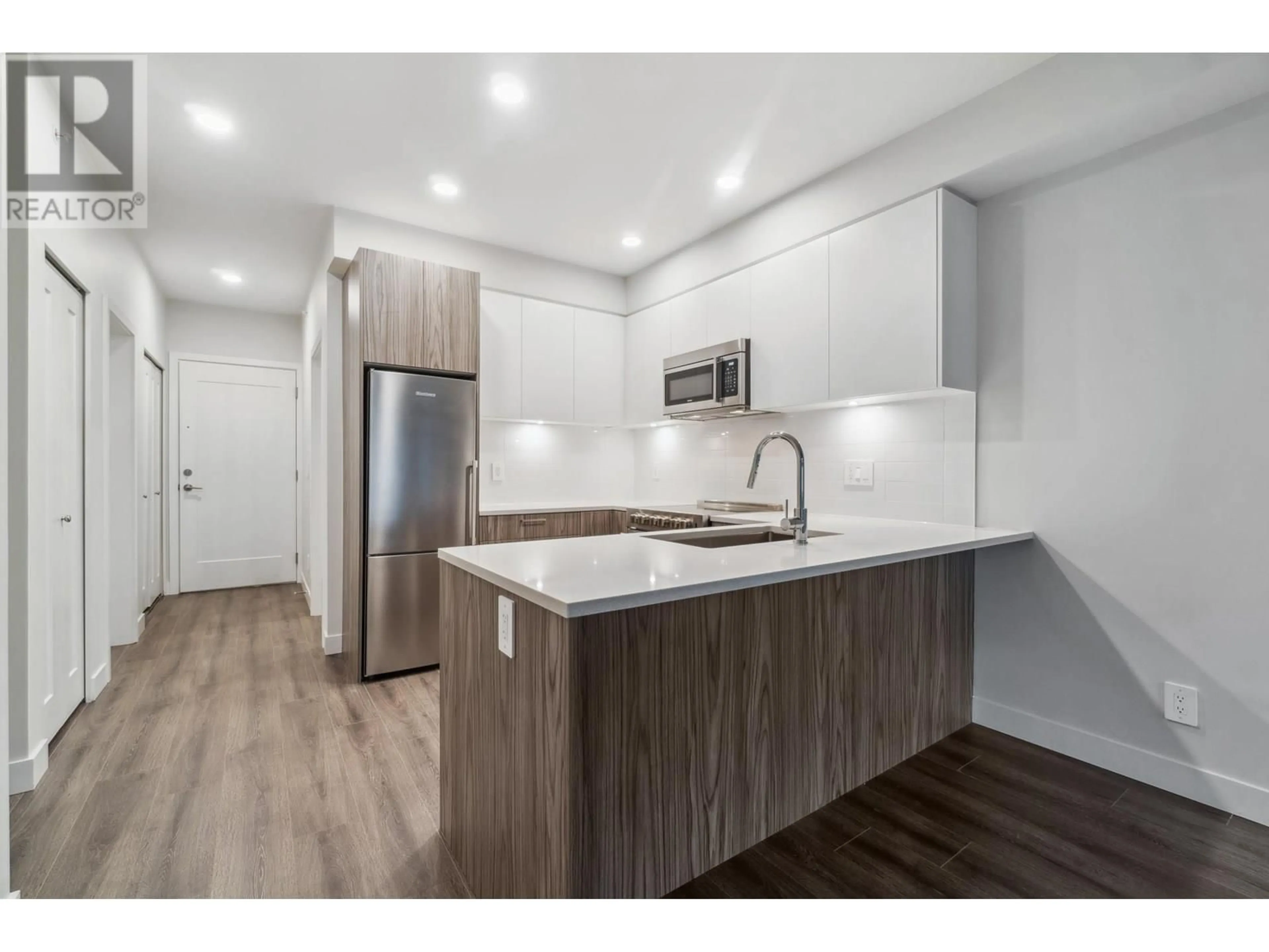 Open concept kitchen, wood/laminate floor for 408 - 5535 HASTINGS STREET, Burnaby British Columbia V5B1R2