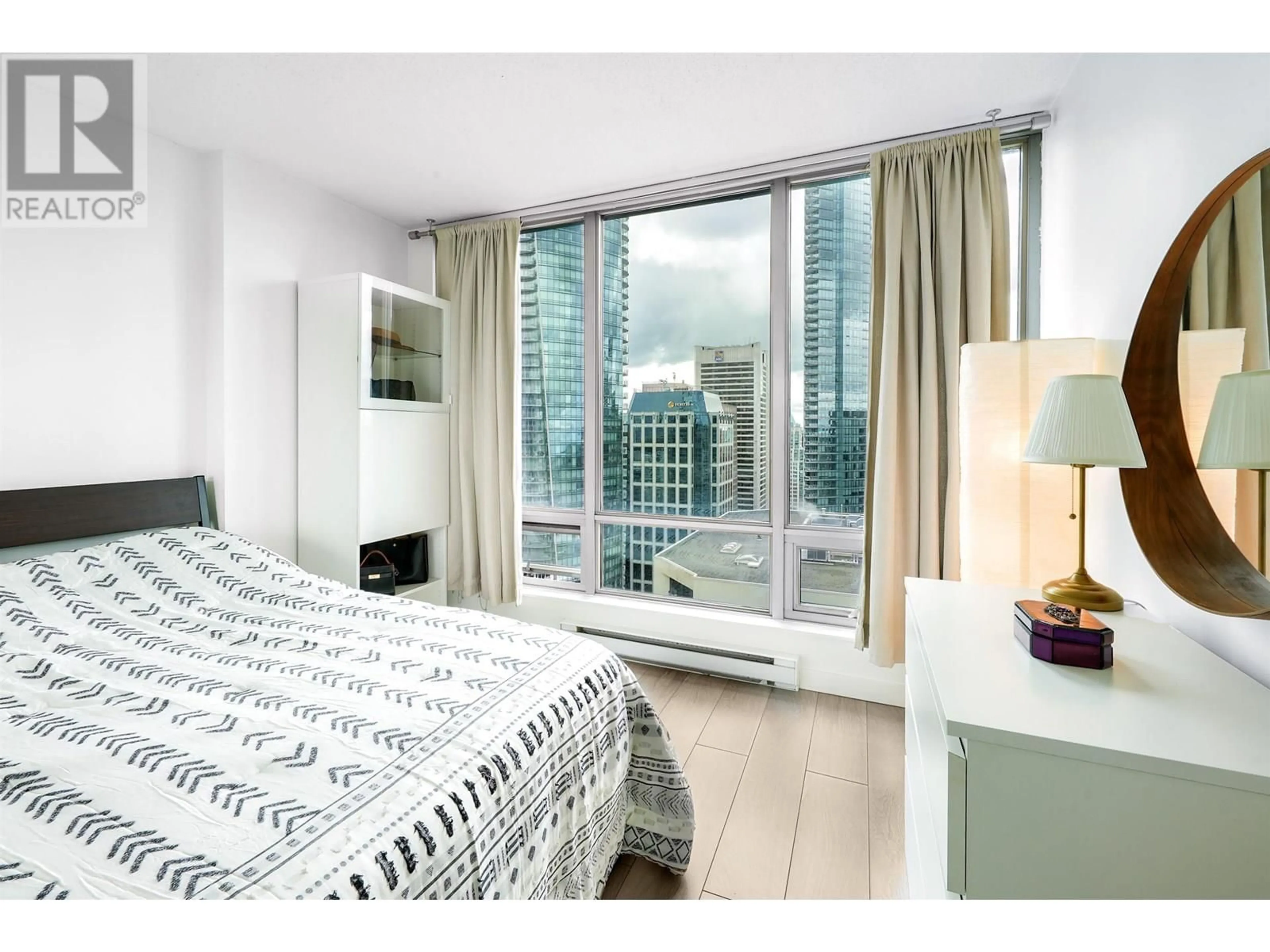 Bedroom with bed, wood/laminate floor for 3304 - 1200 GEORGIA STREET, Vancouver British Columbia V6E4R2