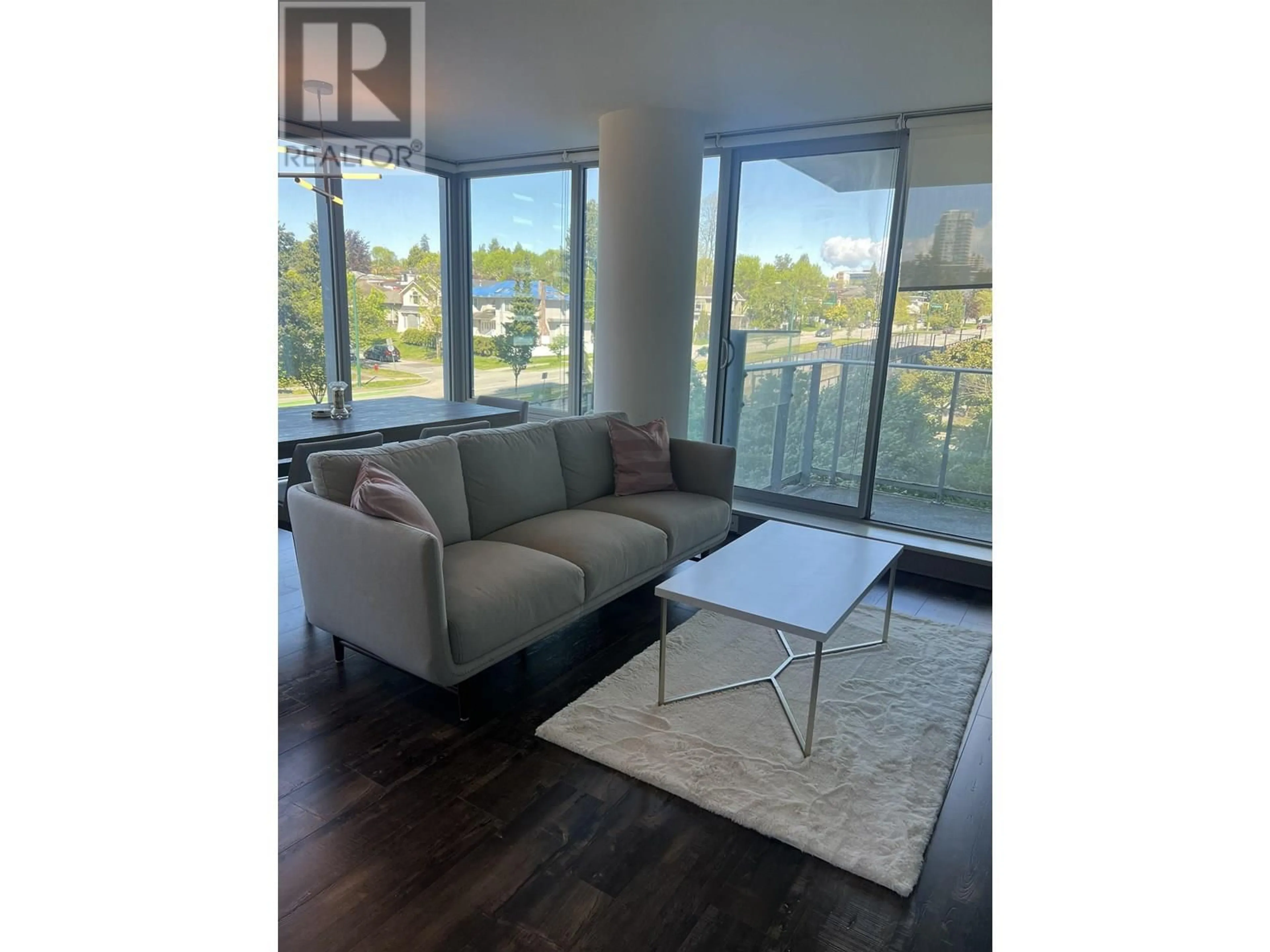Living room with furniture, wood/laminate floor for 302 - 8131 NUNAVUT LANE, Vancouver British Columbia V5X0E2