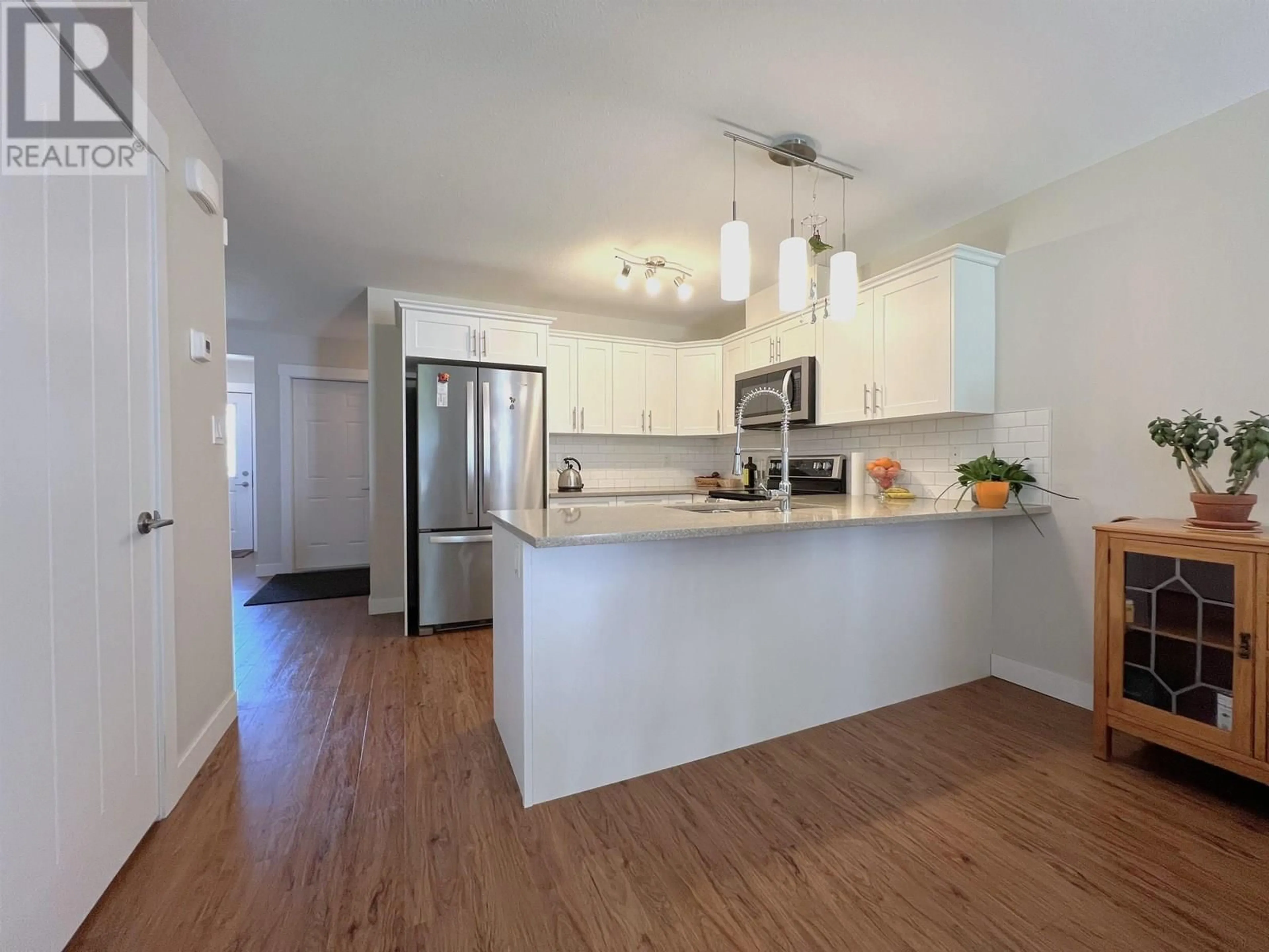 Open concept kitchen, wood/laminate floor for 804 - 6798 WESTGATE AVENUE, Prince George British Columbia V2N0H6