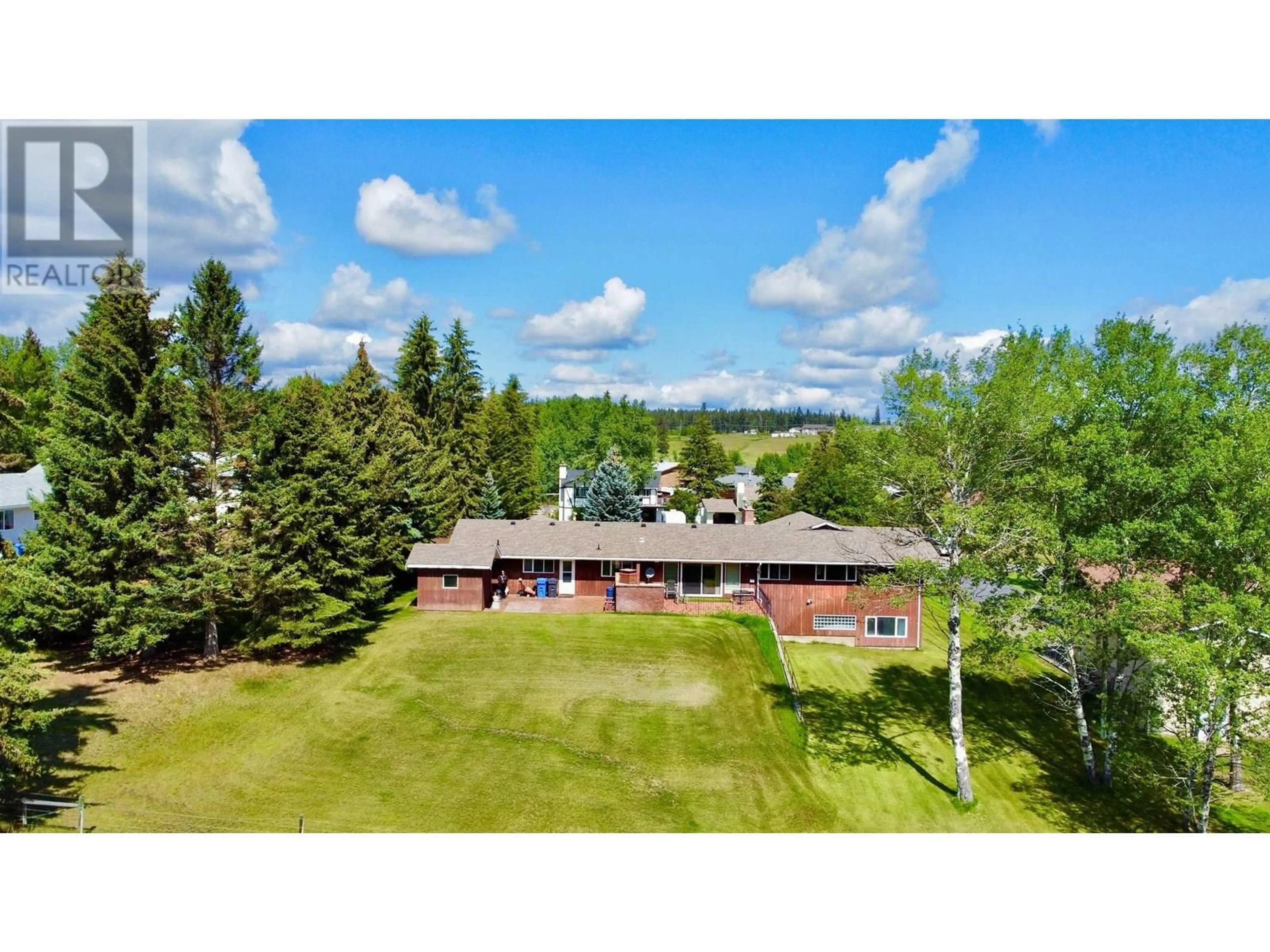 A pic from outside/outdoor area/front of a property/back of a property/a pic from drone, unknown for 355 EVERGREEN CRESCENT, 100 Mile House British Columbia V0K2E0