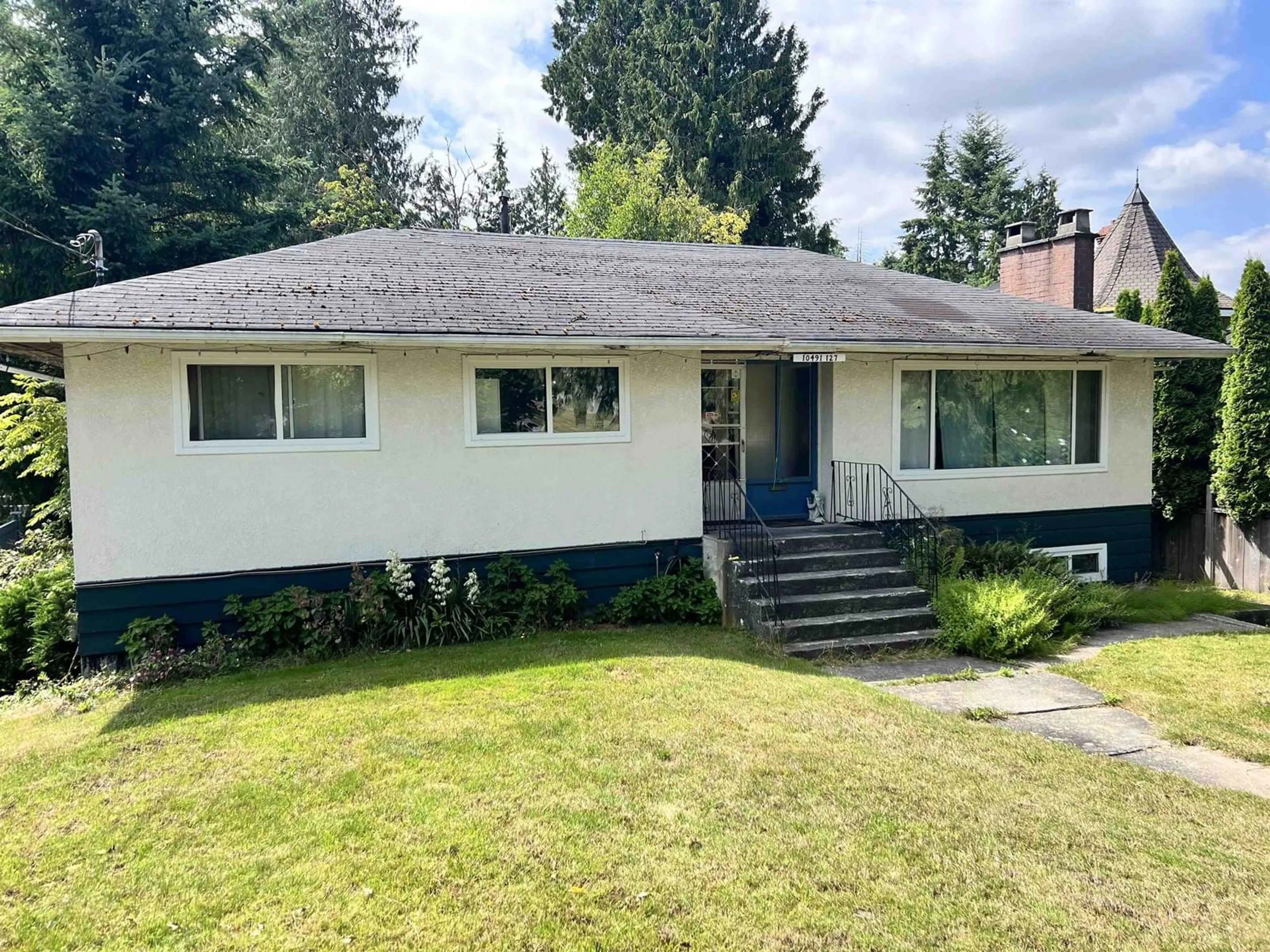 Home with vinyl exterior material, street for 10491 127, Surrey British Columbia V3V5K3