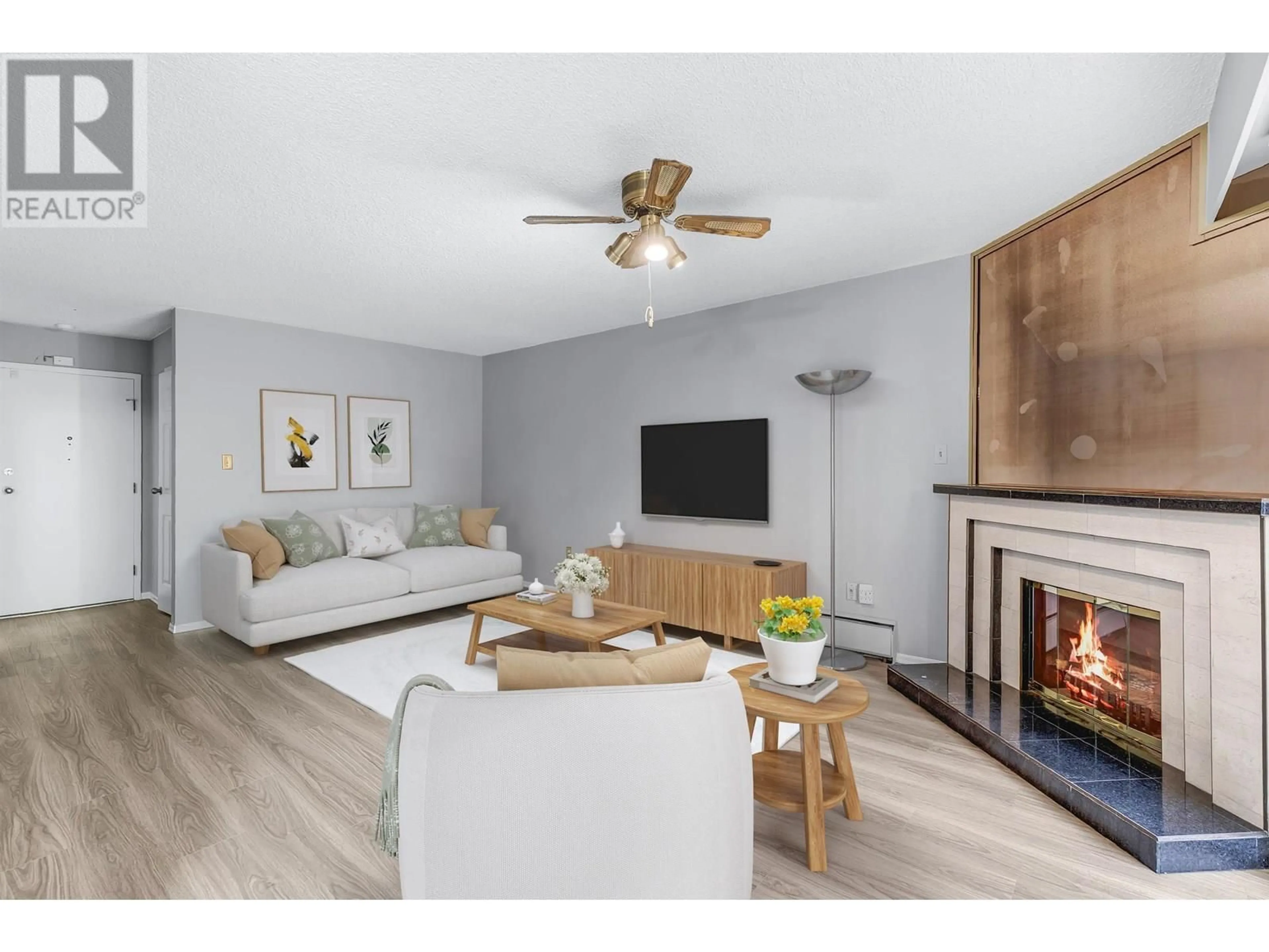 Living room with furniture, wood/laminate floor for 217 - 3901 CARRIGAN COURT, Burnaby British Columbia V3N4K1