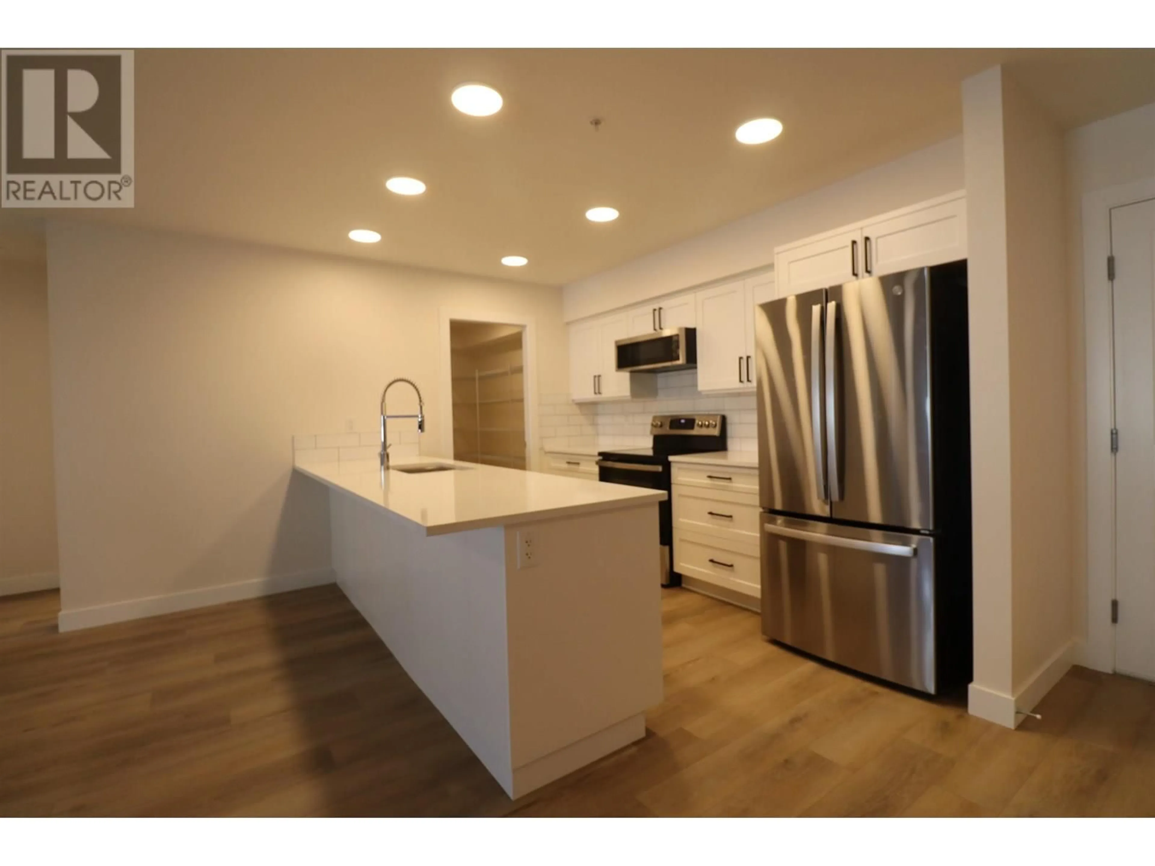 Open concept kitchen, wood/laminate floor for 105 - 4278 22ND AVENUE, Prince George British Columbia V2N0J4