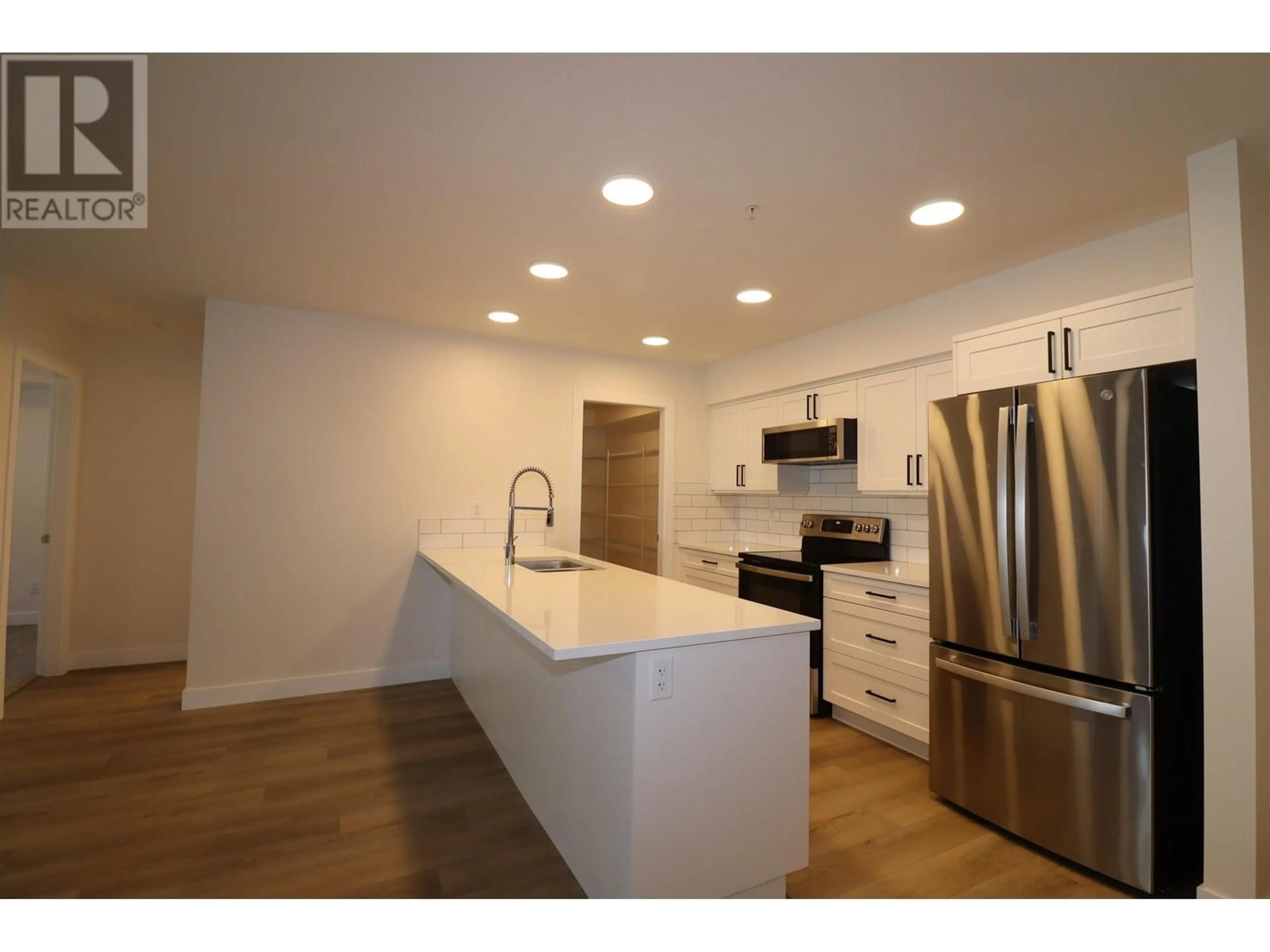 Open concept kitchen, wood/laminate floor for 105 - 4278 22ND AVENUE, Prince George British Columbia V2N0J4