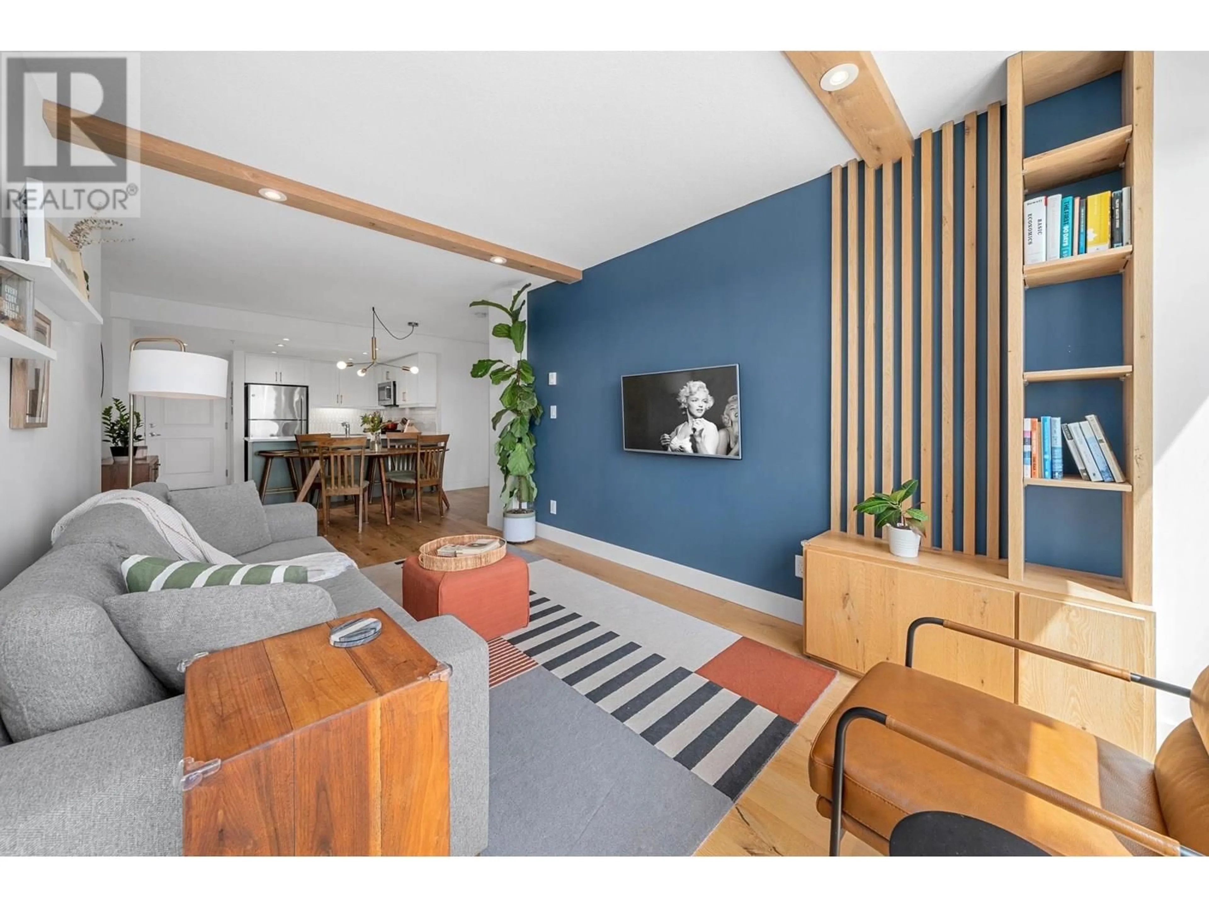 Living room with furniture, wood/laminate floor for 404 - 3811 HASTINGS STREET, Burnaby British Columbia V5C6V2