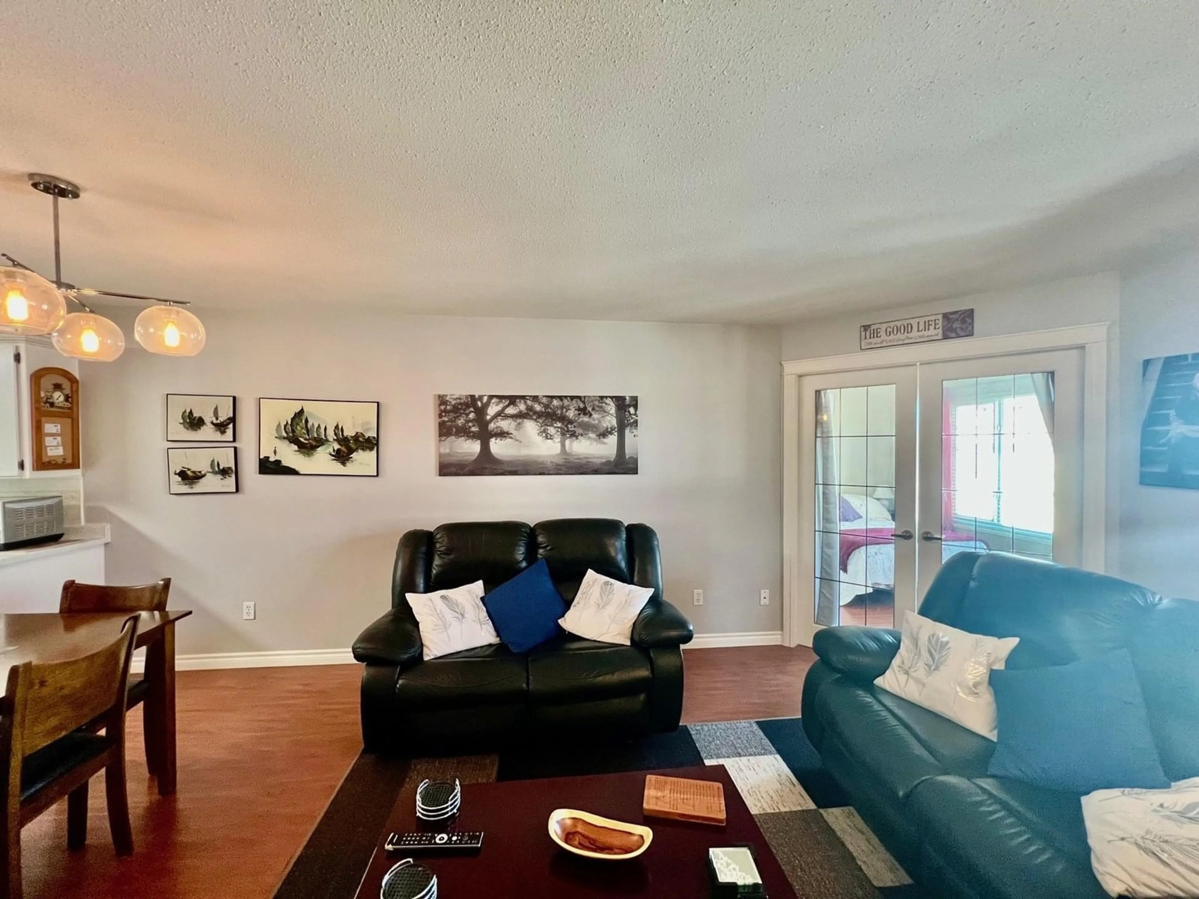 Living room with furniture, wood/laminate floor for 207 - 45660 KNIGHT ROAD, Chilliwack British Columbia V2R2X4