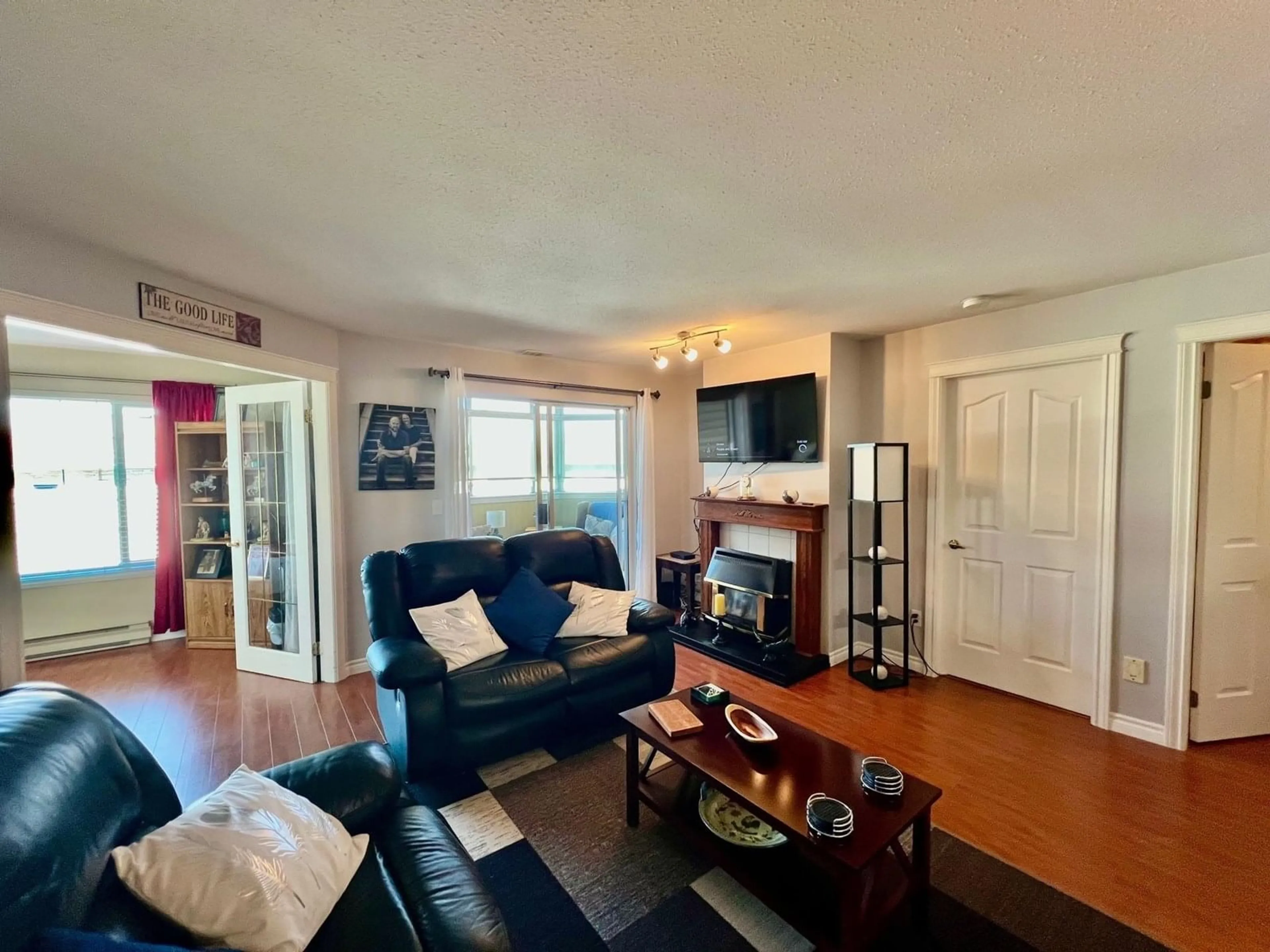 Living room with furniture, wood/laminate floor for 207 - 45660 KNIGHT ROAD, Chilliwack British Columbia V2R2X4