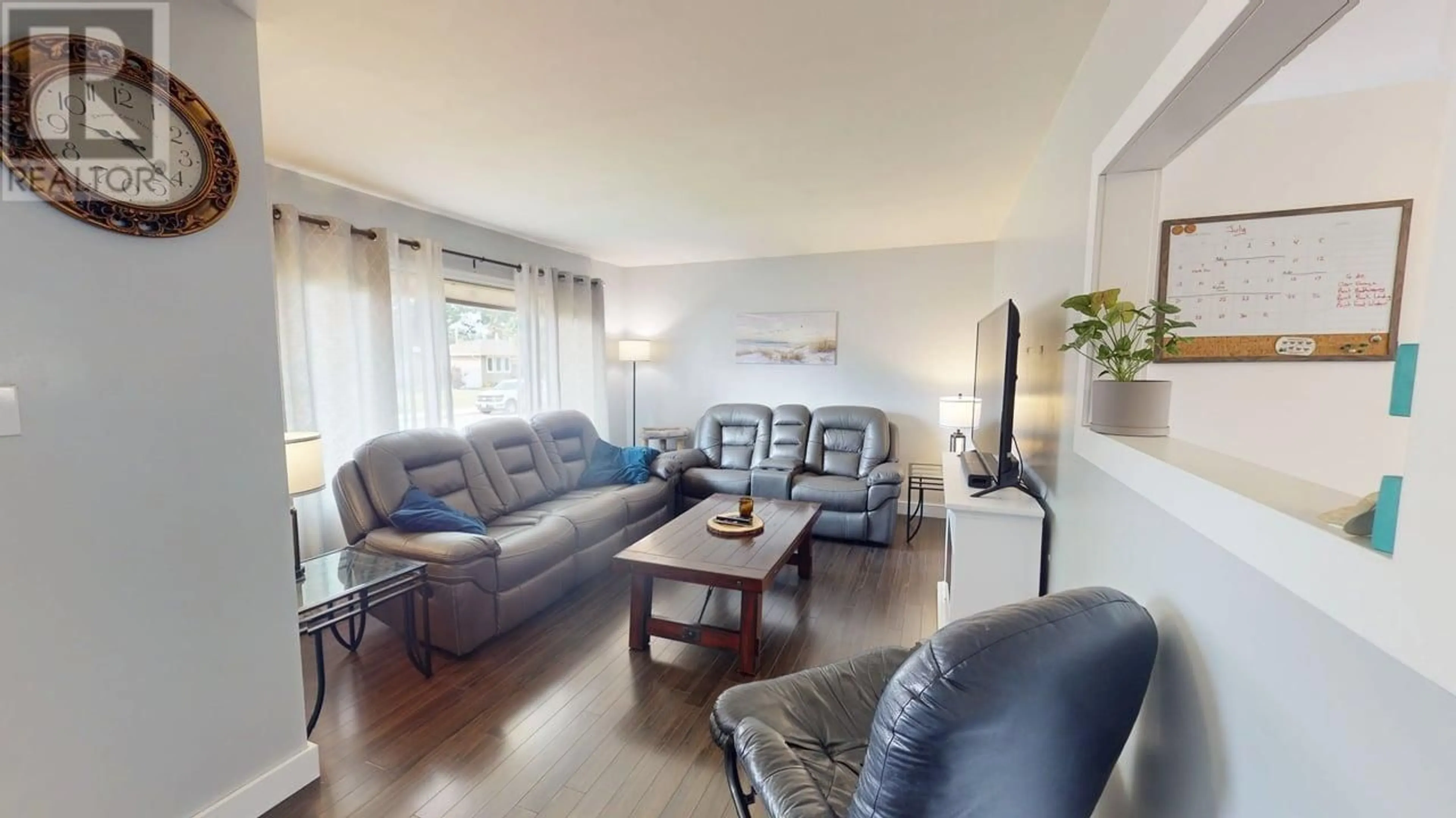 Living room with furniture, wood/laminate floor for 9316 111 AVENUE, Fort St. John British Columbia V1J2T7