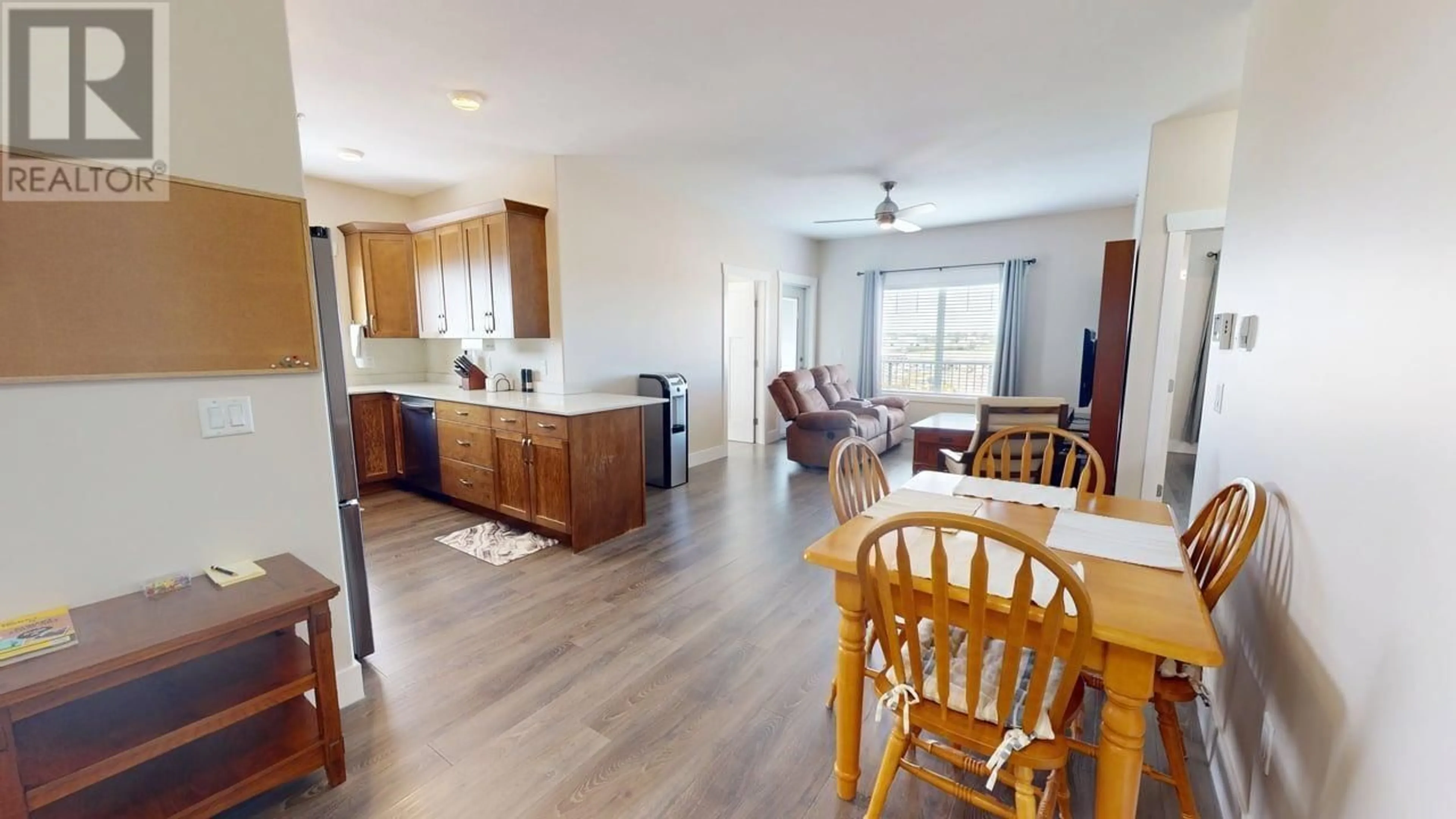 Open concept kitchen, wood/laminate floor for 404 - 11205 105 AVENUE, Fort St. John British Columbia V1J0L3