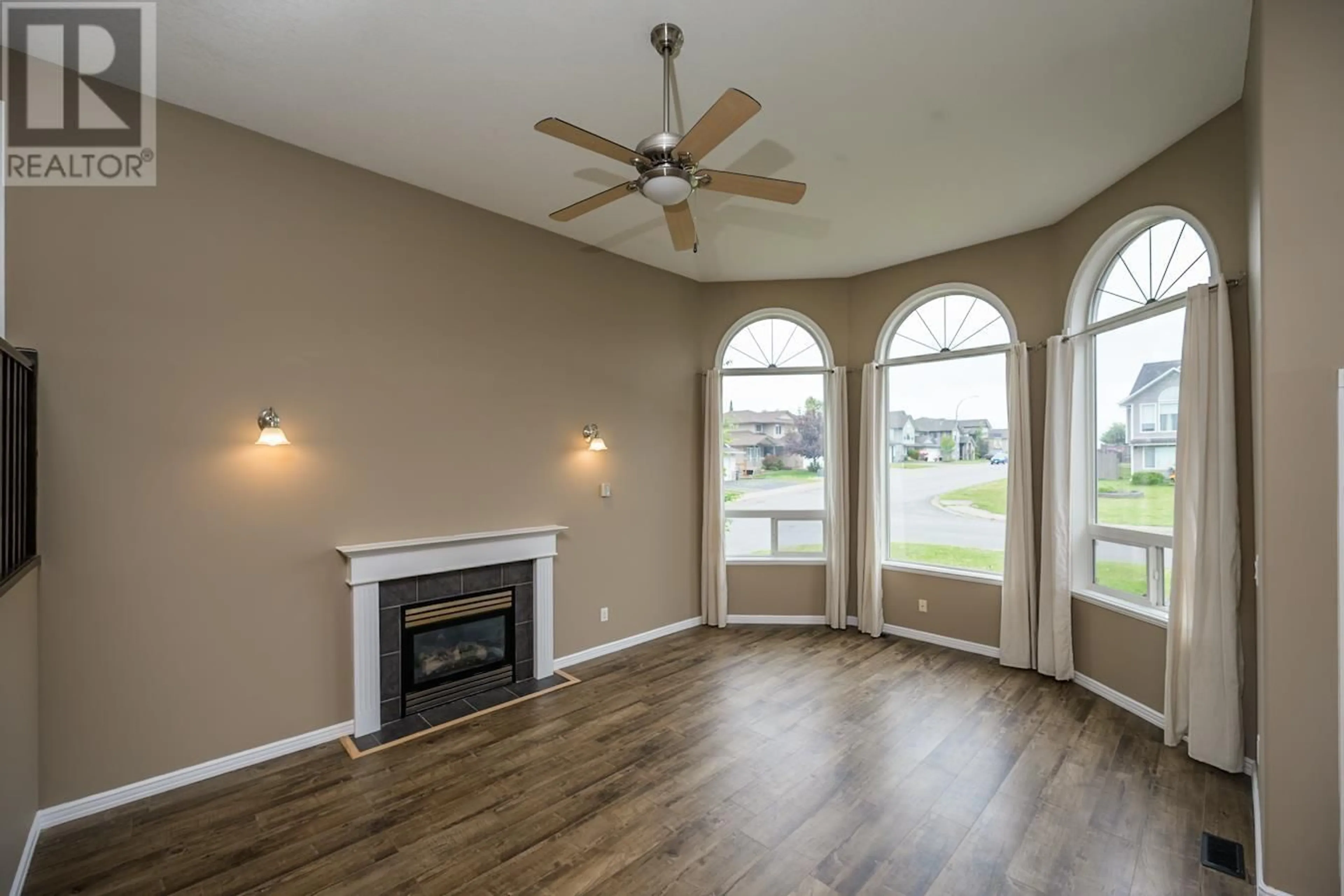 Living room with furniture, wood/laminate floor for 7003 TRYGG COURT, Prince George British Columbia V2N6Z8