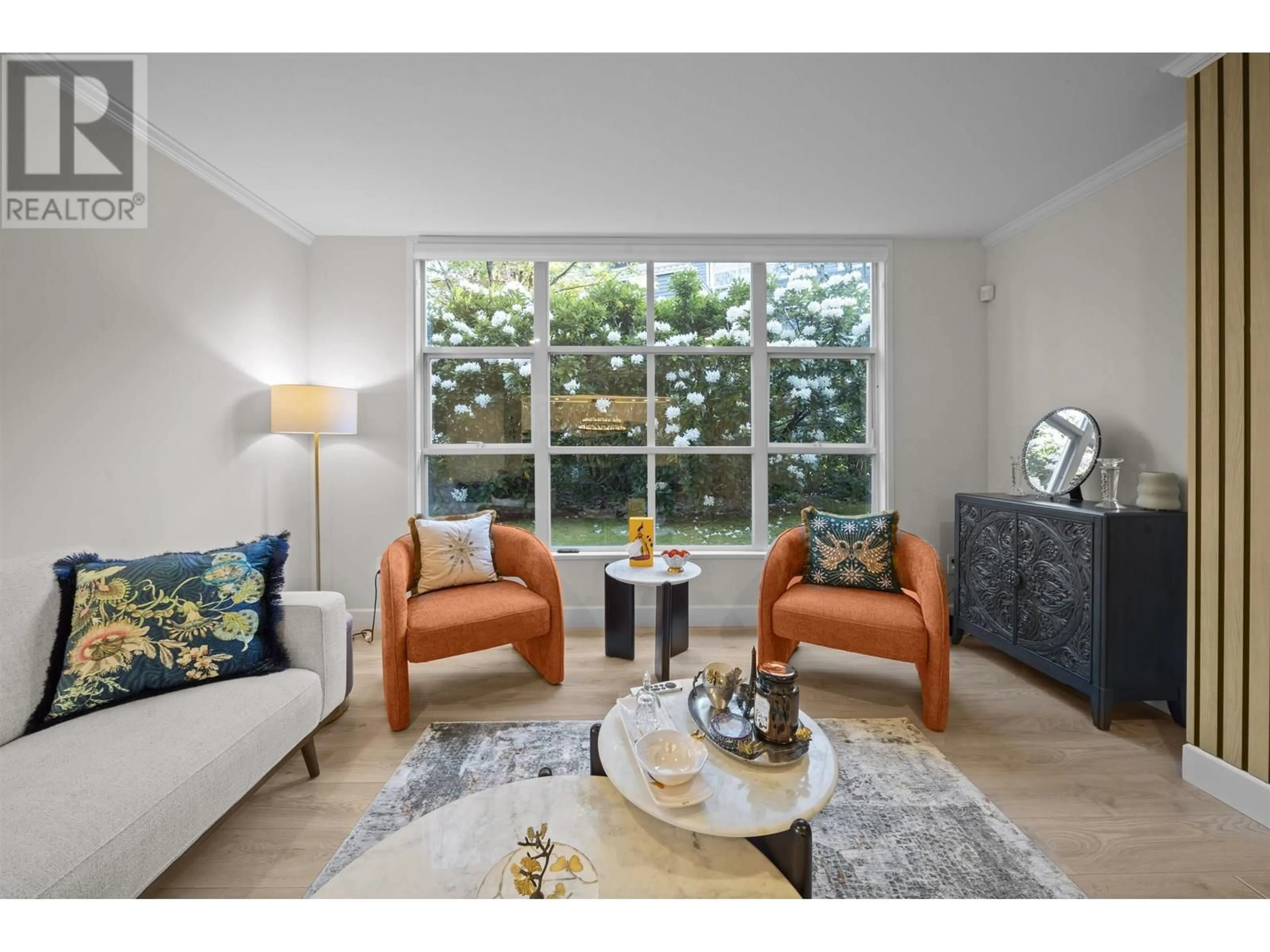 Living room with furniture, wood/laminate floor for 103 - 3399 CAPILANO CRESCENT, North Vancouver British Columbia V7R4W7