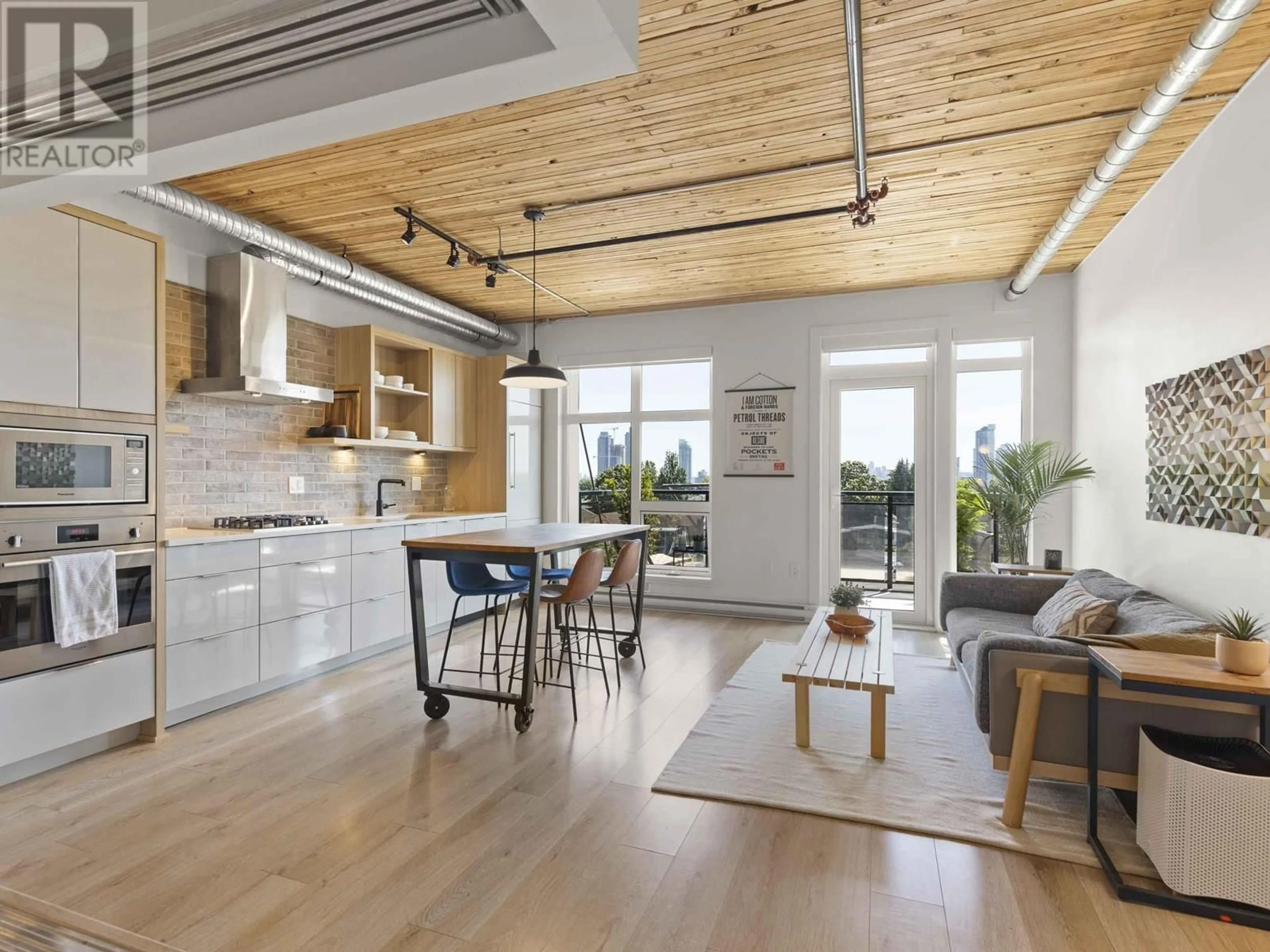 Open concept kitchen, wood/laminate floor for 308 - 4223 HASTINGS STREET, Burnaby British Columbia V5C2J5