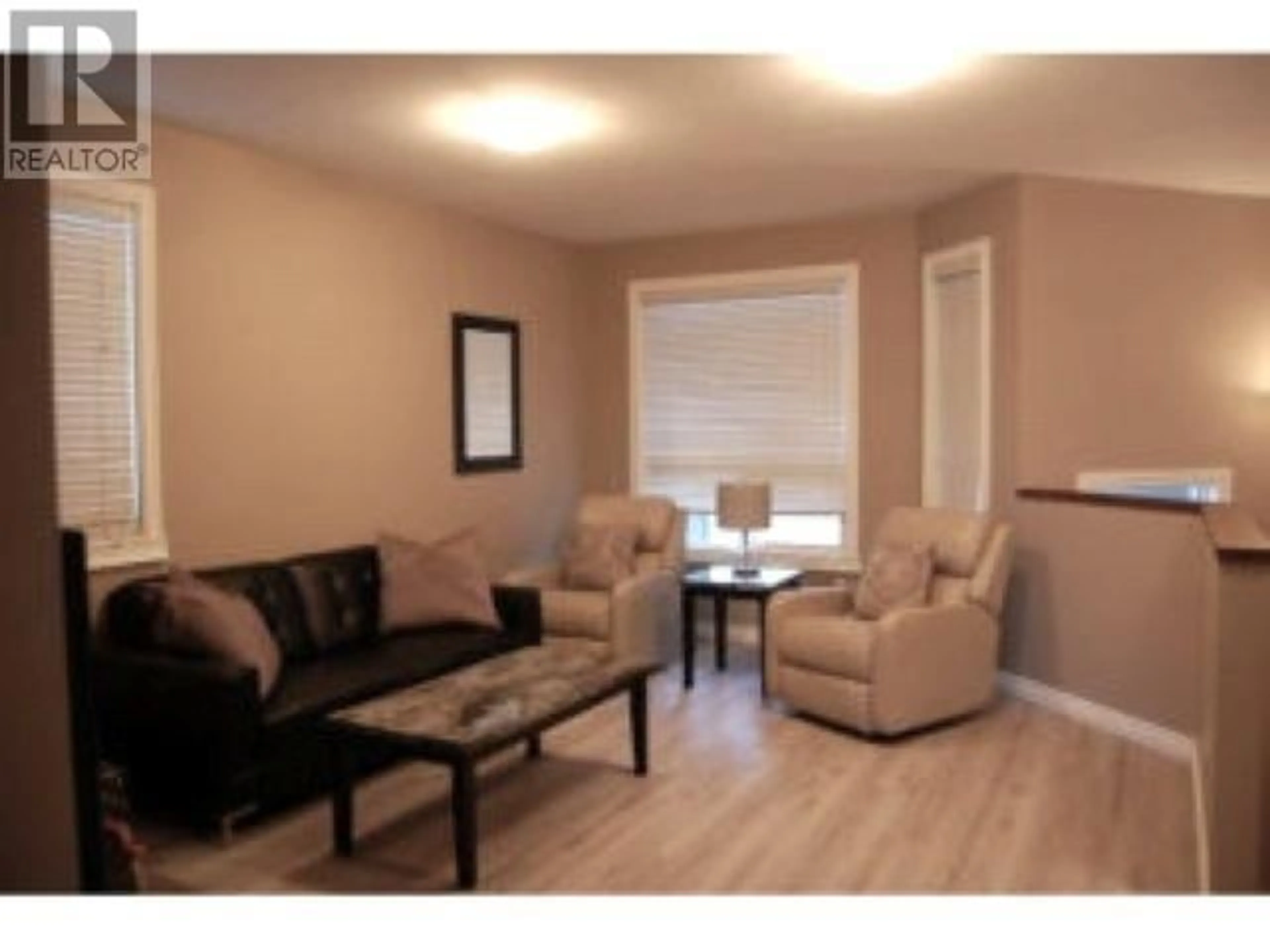 Living room with furniture, wood/laminate floor for 8703 82 STREET, Fort St. John British Columbia V1J0N8