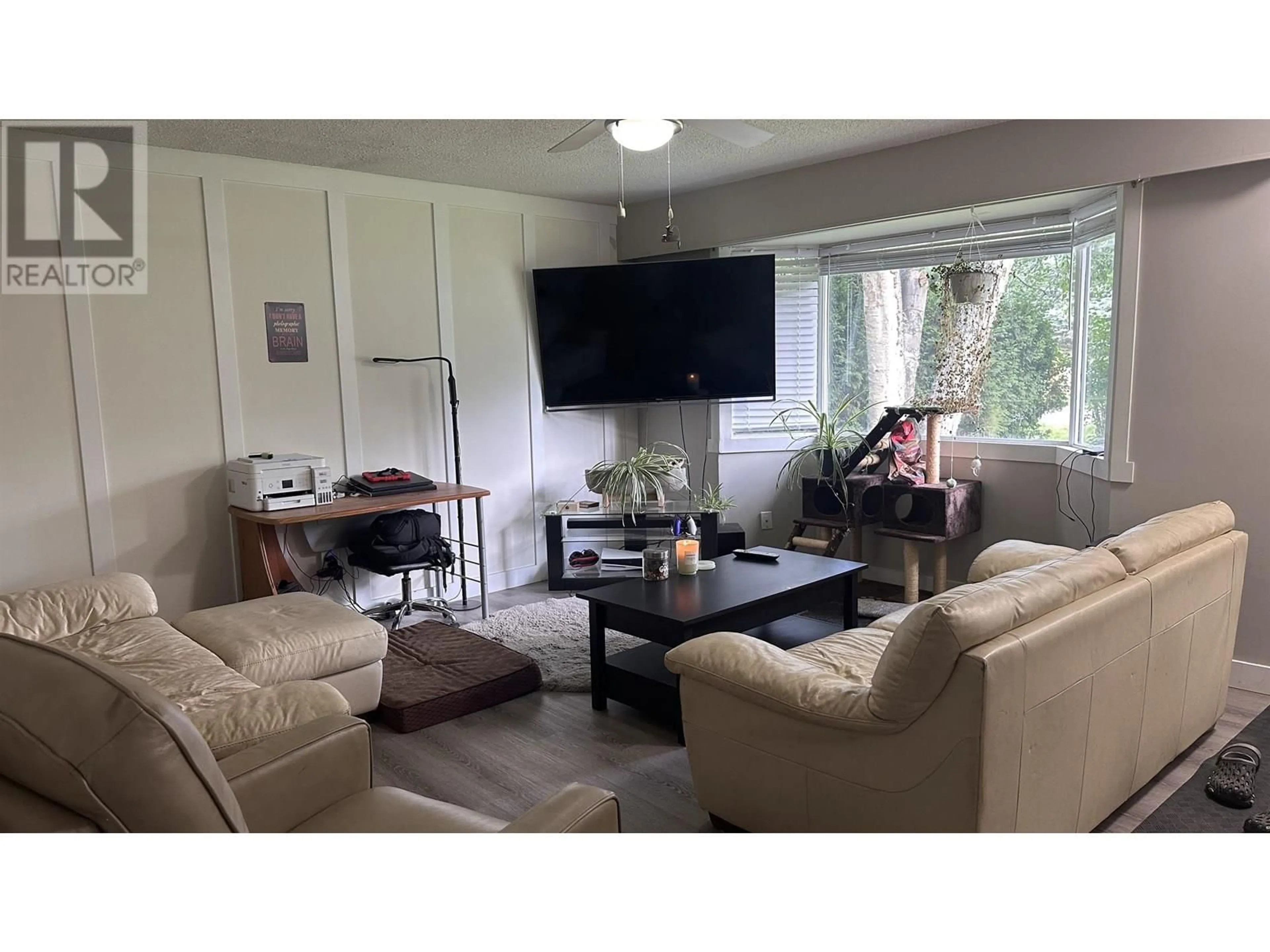 Living room with furniture, wood/laminate floor for 6073 BIRCHWOOD CRESCENT, Prince George British Columbia V2K1W5