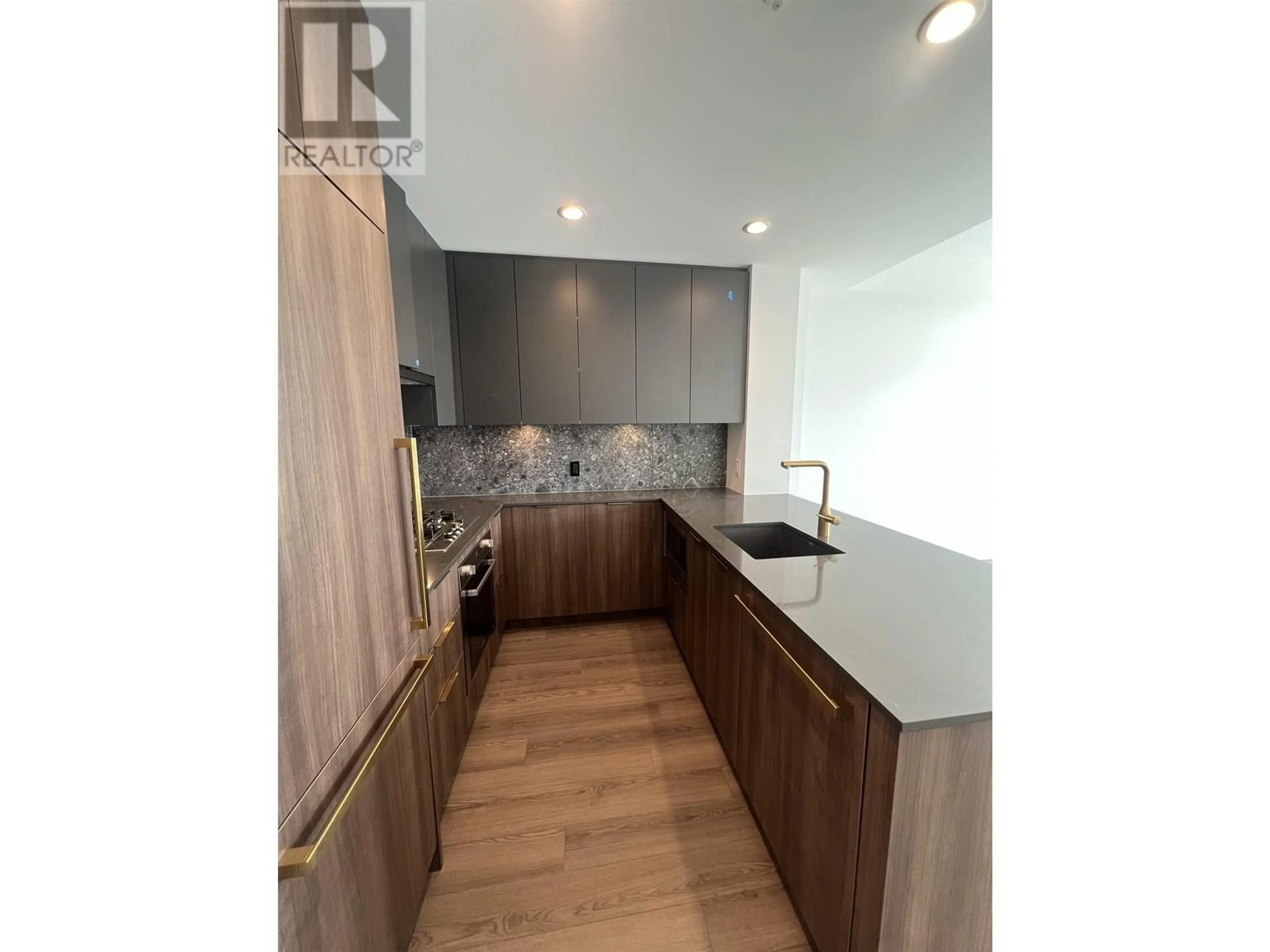 Open concept kitchen, wood/laminate floor for 409 - 2385 EMERY COURT, North Vancouver British Columbia V7J0E8