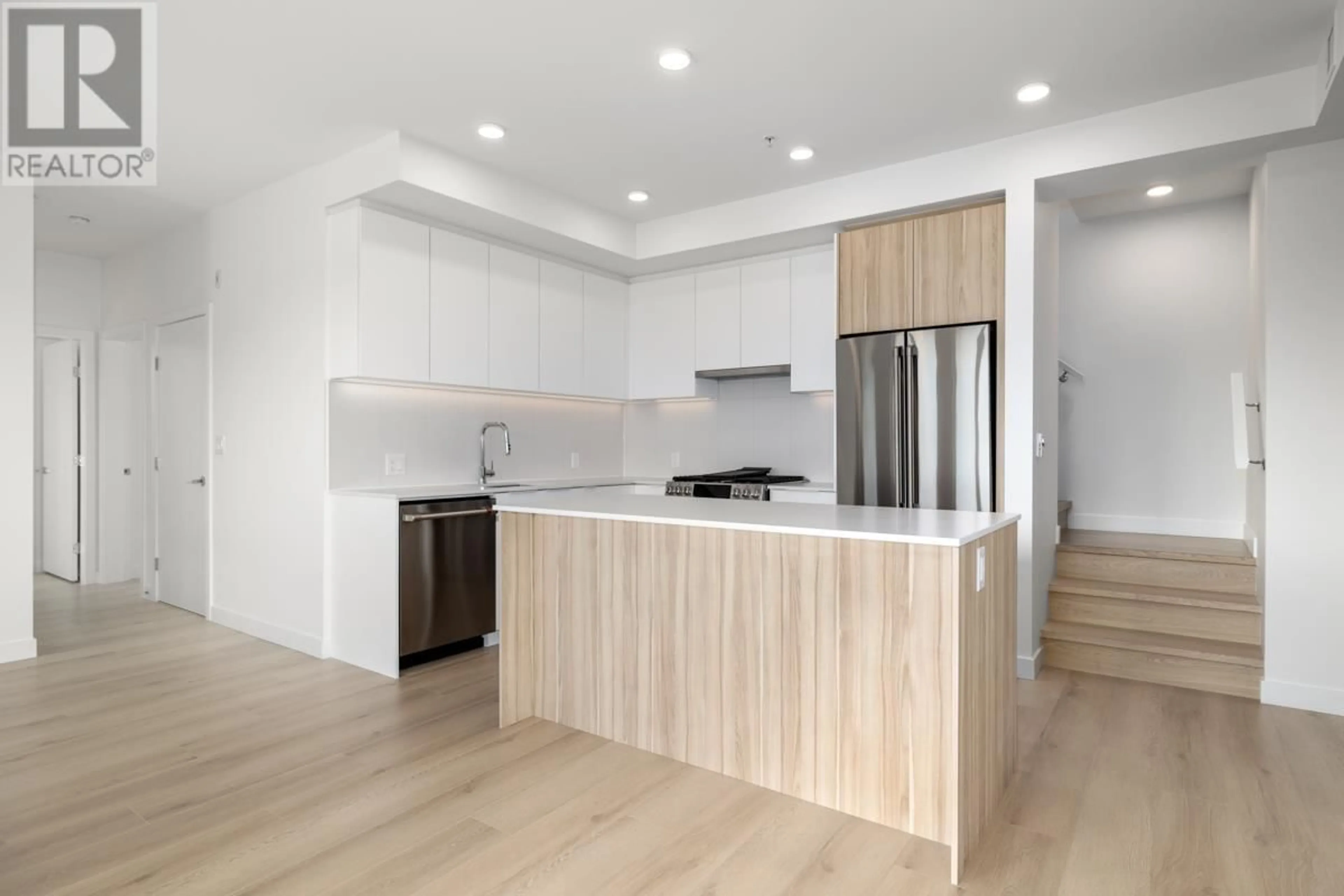 Open concept kitchen, wood/laminate floor for 605 - 2450 GARDEN DRIVE, Vancouver British Columbia V5N0K1