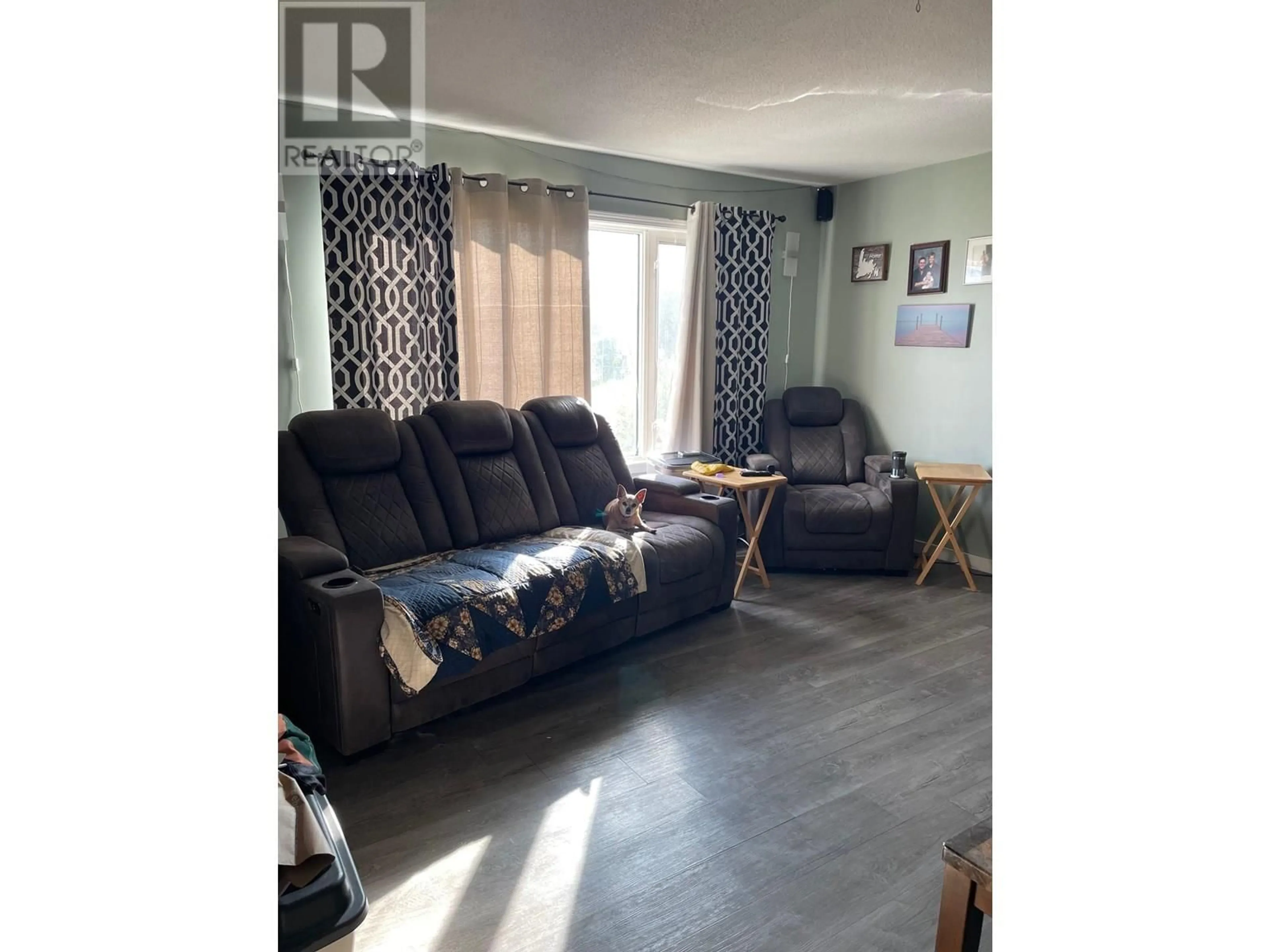Living room with furniture, wood/laminate floor for 4620 BOUNDARY ROAD, Fort Nelson British Columbia V0C1R0